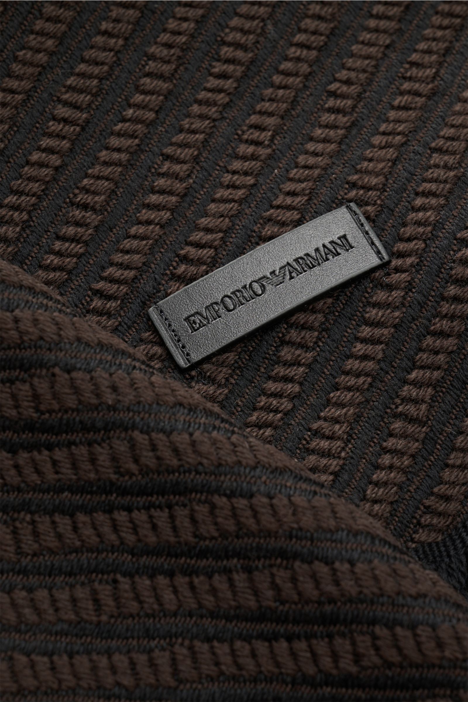 Emporio Armani Schal dunkelbraun/schwarz gestreift aus reiner Schurwolle mit diagonalem Webmuster, Leder-Logo-Patch und Fransensaum, Nahaufnahme.