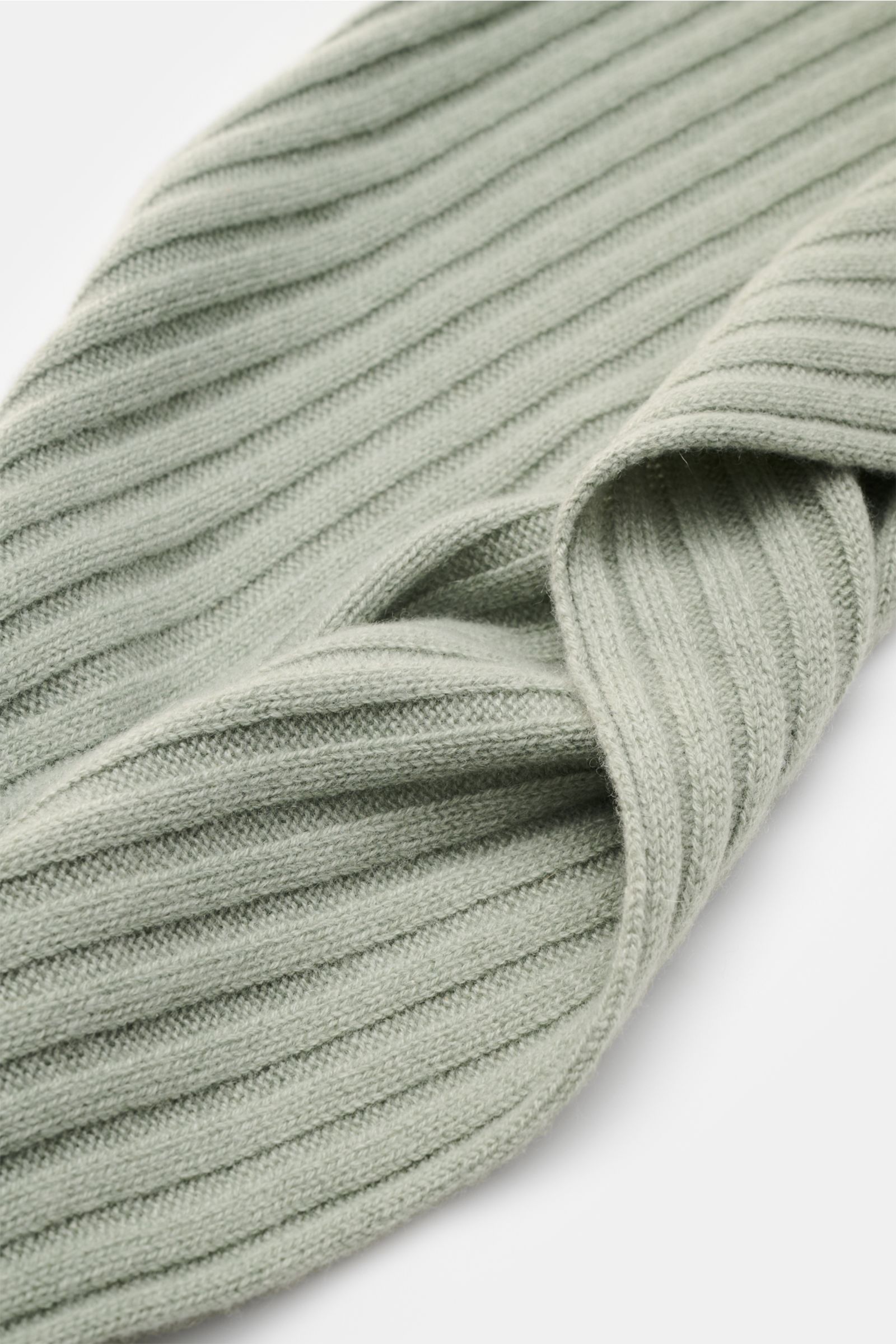 Nahaufnahme des FTC Cashmere Schals graugrün mit breitem Rippstrickmuster und weichem Griff, von oben schräg fotografiert.