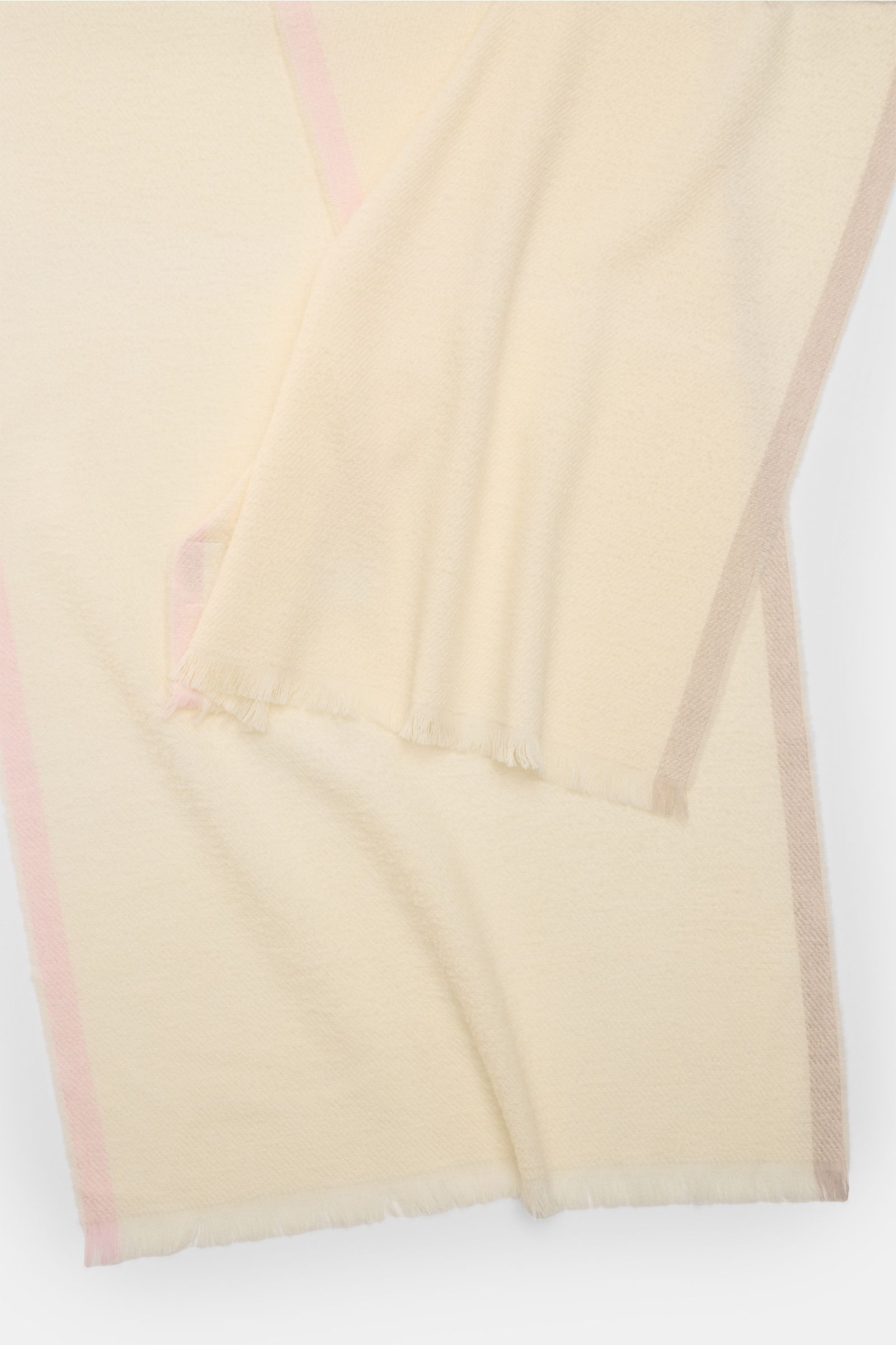 Cream scarf 04651/ A trip in a bag Scarf cream photographed from above showing fine virgin wool blend, soft feel, narrow fringed edge.