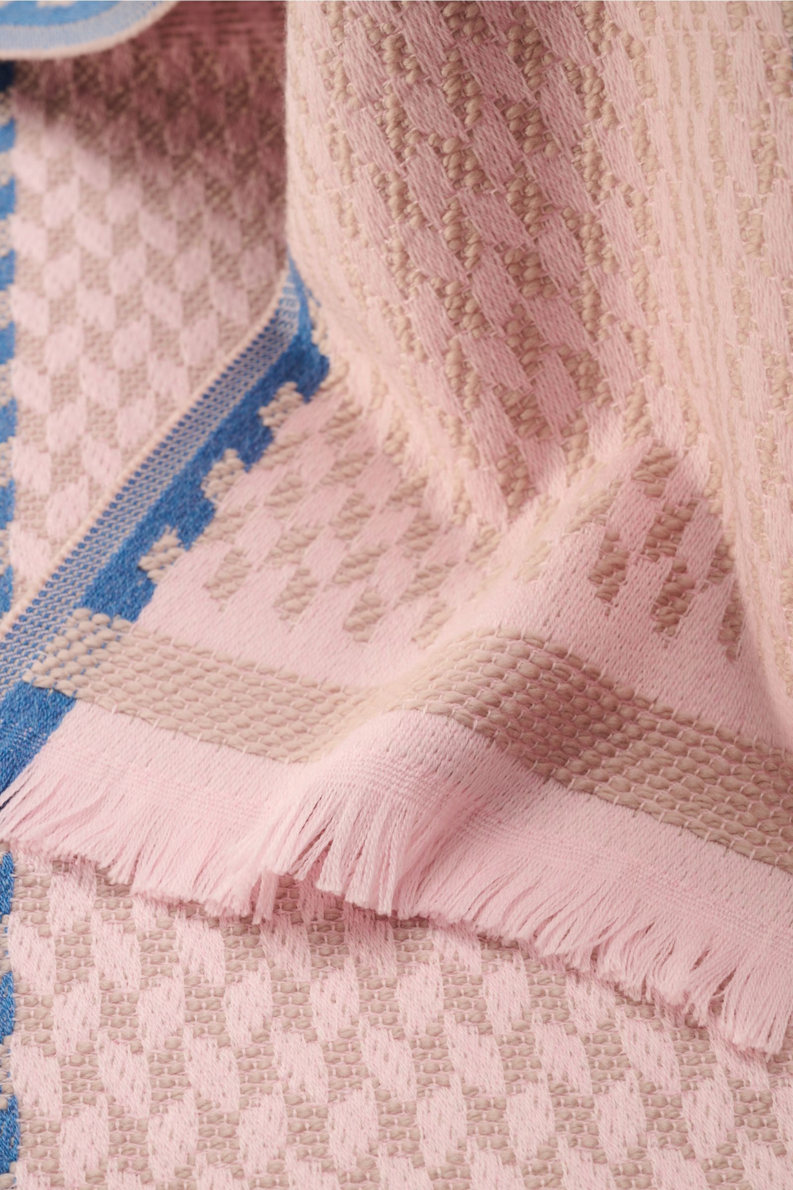 Close-up, top-down view of the 04651/ A trip in a bag Scarf '3D Jacquard' rose/beige/smoky blue patterned, showcasing fine virgin wool, soft feel, graphic pattern, narrow fringed edge, approx. 190 cm x 37 cm. A luxurious eye-catcher for winter with intric