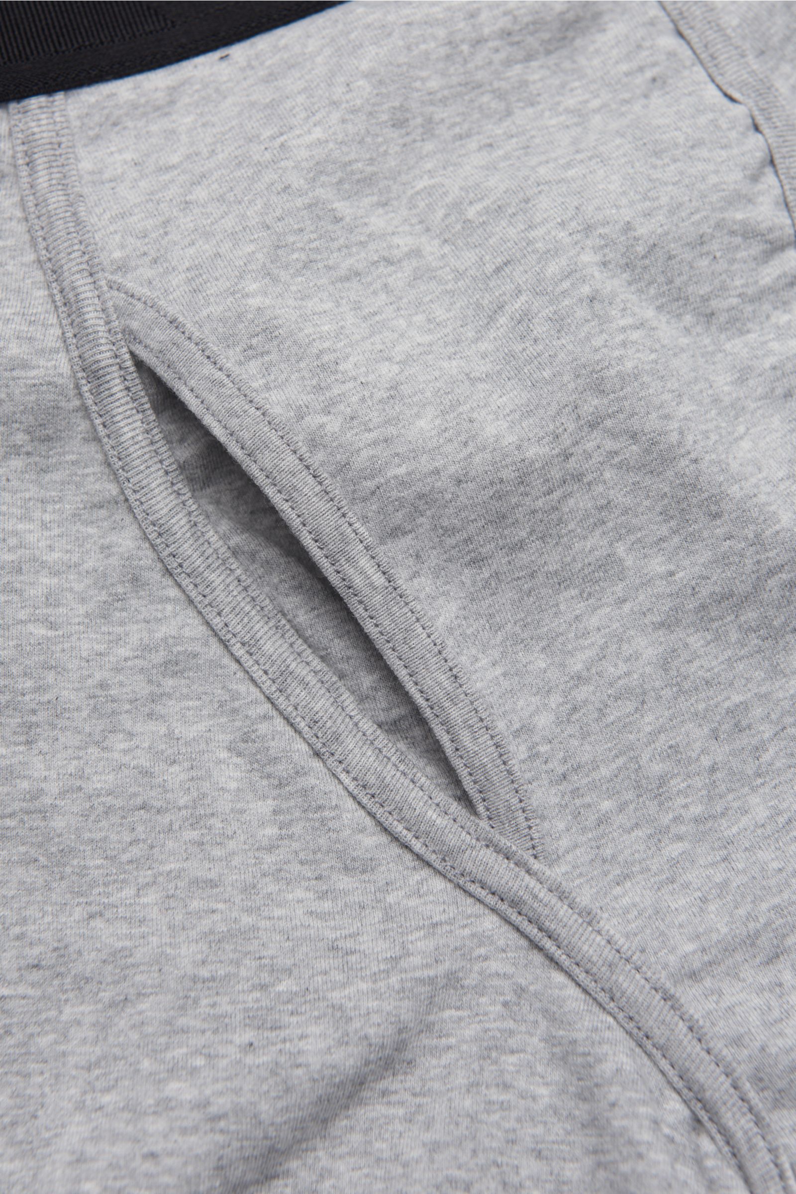 Close-up front view of Tom Ford Boxer shorts grey showing keyhole fly, elastic cotton fabric, and fine stitching on smooth, soft-touch material.