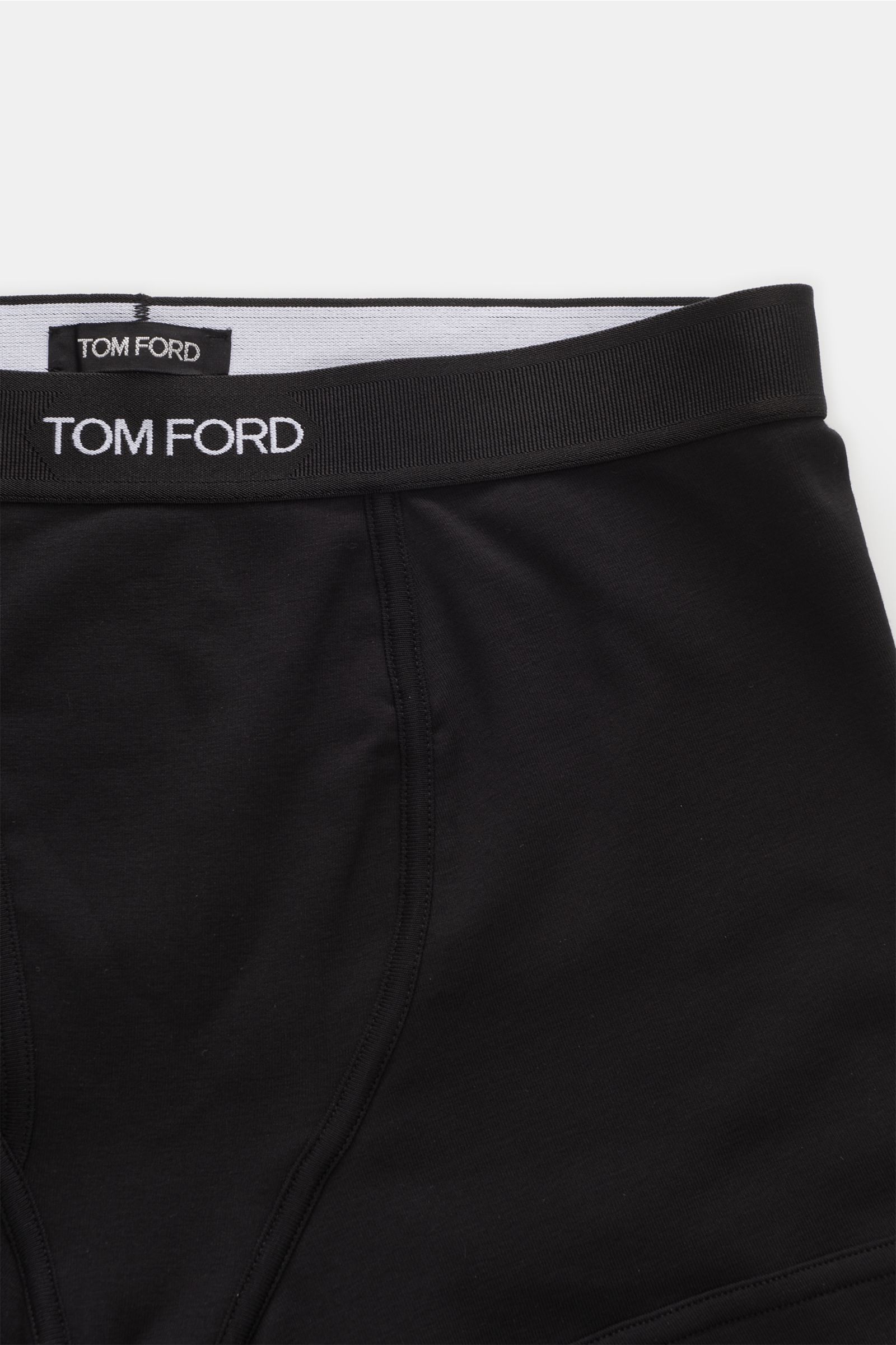 Close-up front view of Tom Ford Boxer shorts pack of 2 black/dark brown, showing elasticated waistband with TOM FORD stitching and keyhole fly. Sporty, simple and luxurious: These comfortable boxer shorts with practical fly and TOM FORD stitching on the e