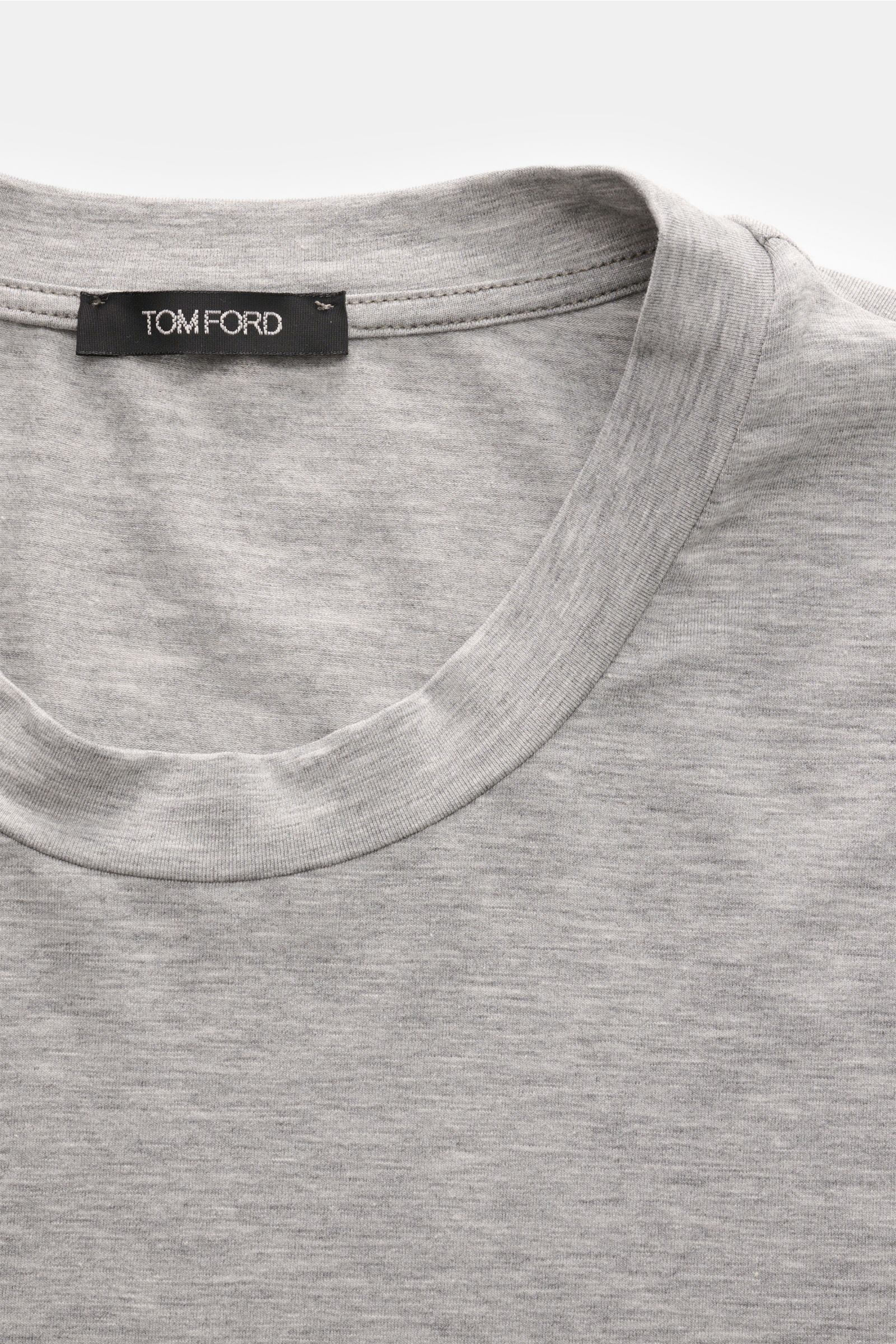 Close-up from above of the Tom Ford Langarm-Unterhemd schwarz showing the round neckline, soft cotton-modal fabric, and small TOM FORD label on hem.

Description: Cleanes Basic mit Rundhalsausschnitt: Das komfortable Langarmshirt aus hochwertiger Baumw