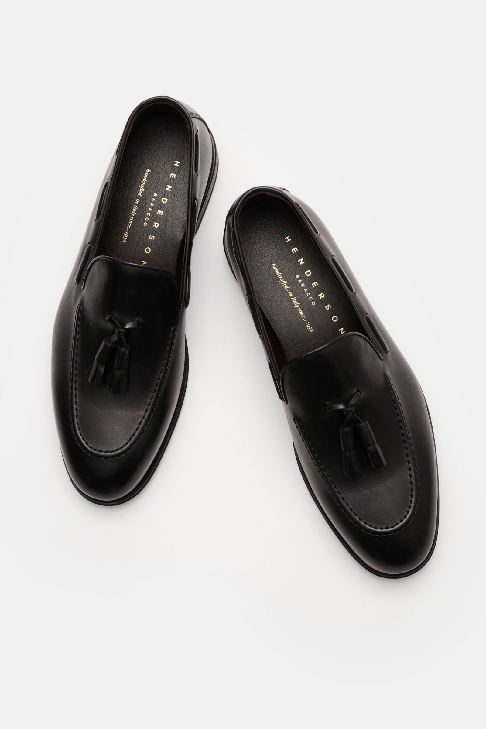 Henderson Tassel Loafer dunkelbraun shown from a top-down perspective, featuring hand-antiqued calf leather, narrow silhouette, Blake construction, decorative leather band with tassel, leather lining, leather and rubber sole, and rubber-reinforced heel.  