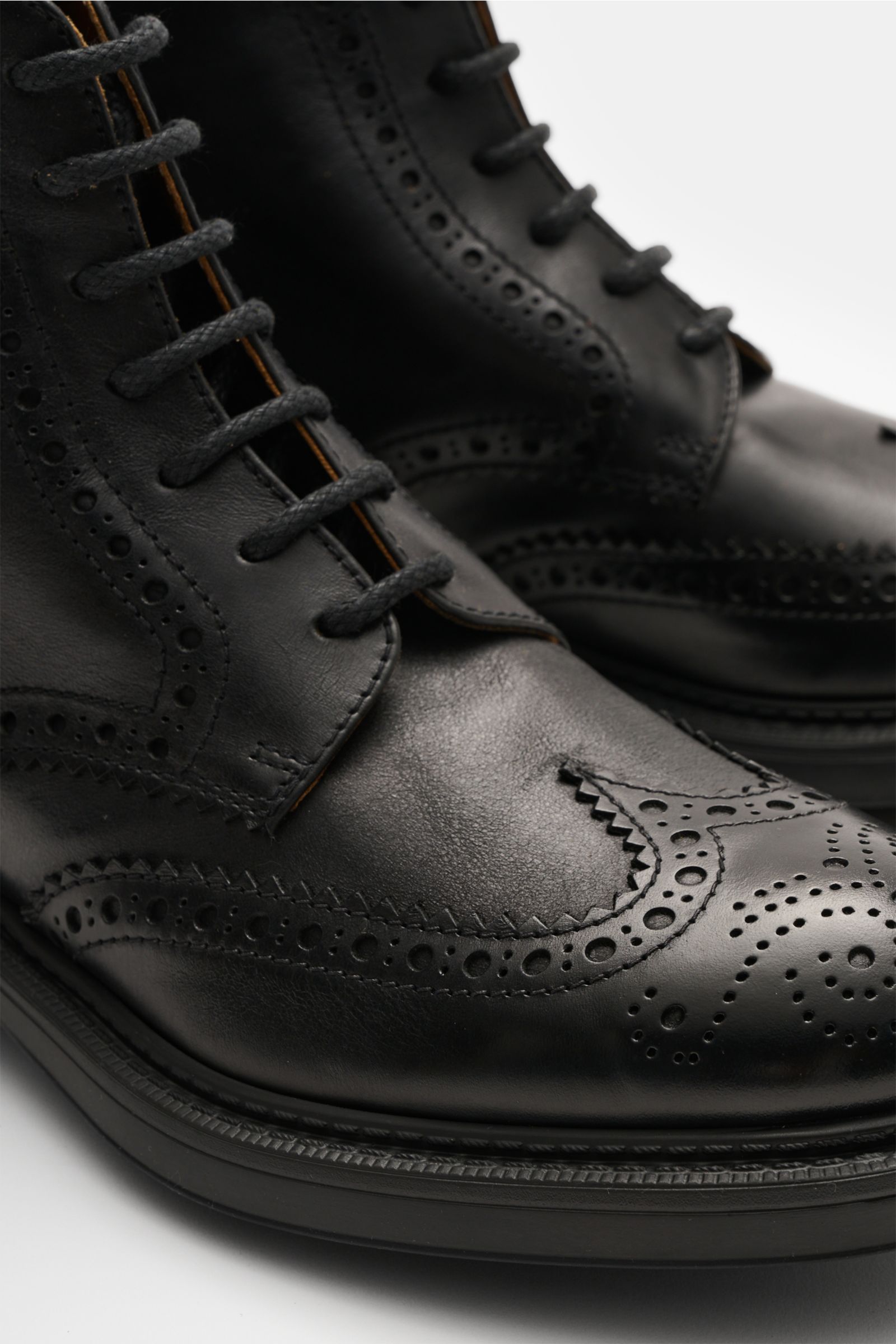 Nahaufnahme von Doucal's Schnürboot schwarz aus genarbtem Leder mit feinen Brogueings, sieben-Loch-Schnürung, Profilsohle.