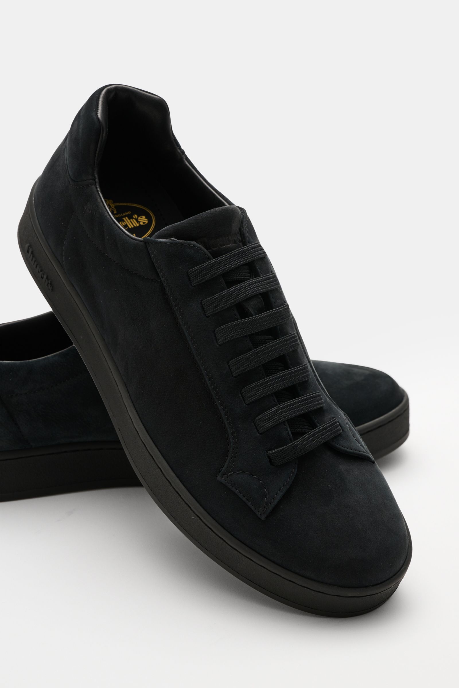 Front-side view of Church's Sneaker 'Ludlow' schwarz, a sleek black slip-on sneaker with smooth Nappa leather and elastic closed lacing.

Description: Mit diesem schlichten Slip-on-Sneaker aus feinstem Nappaleder mit elastischer, geschlossener Schnür