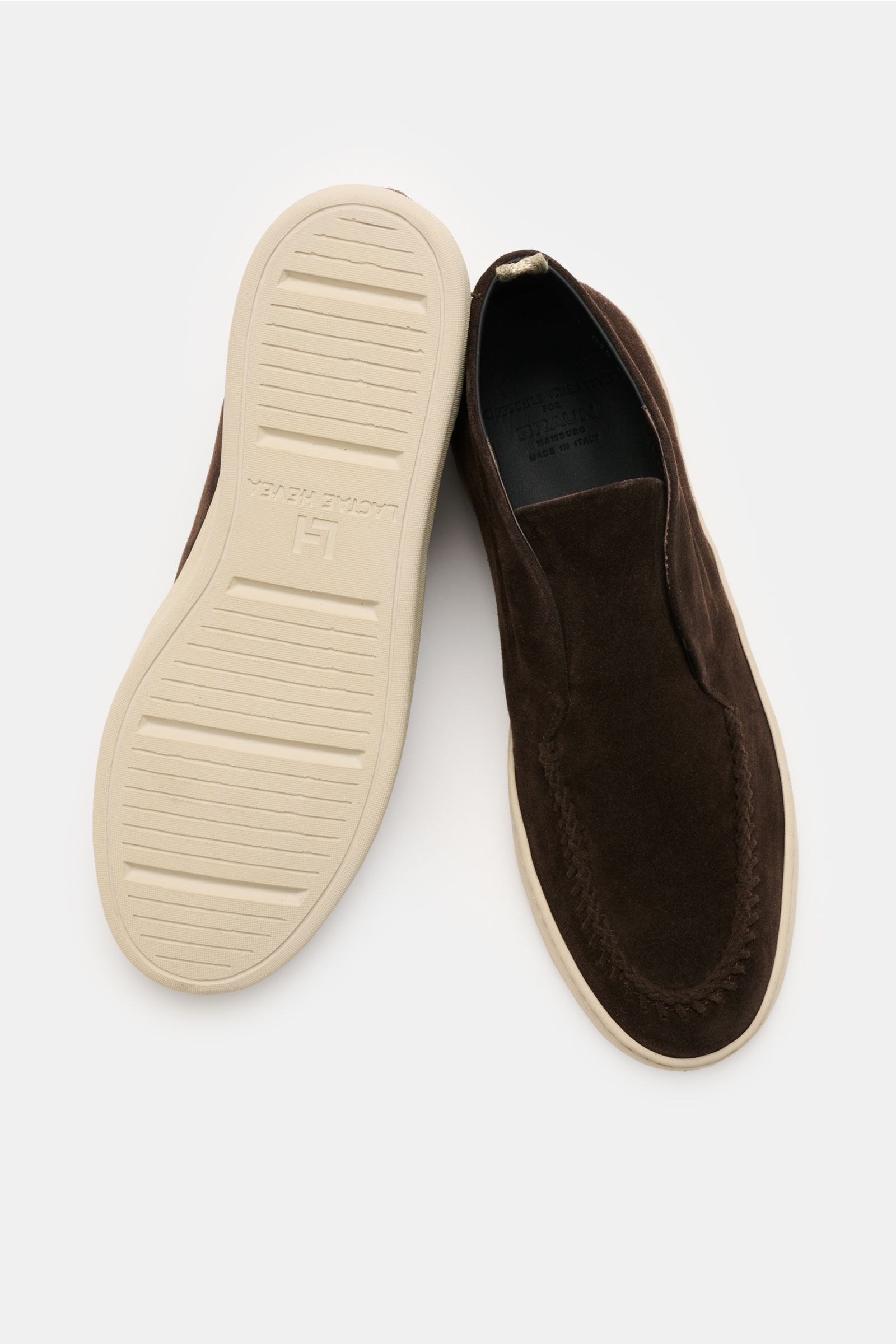 Officine Creative Loafer 'Herbie' dunkelbraun shown from above with one shoe sole up, featuring smooth velour leather, slim silhouette, decorative stitch, grosgrain loop, leather lining, and flexible rubber sole for secure comfort and stylish high-top des