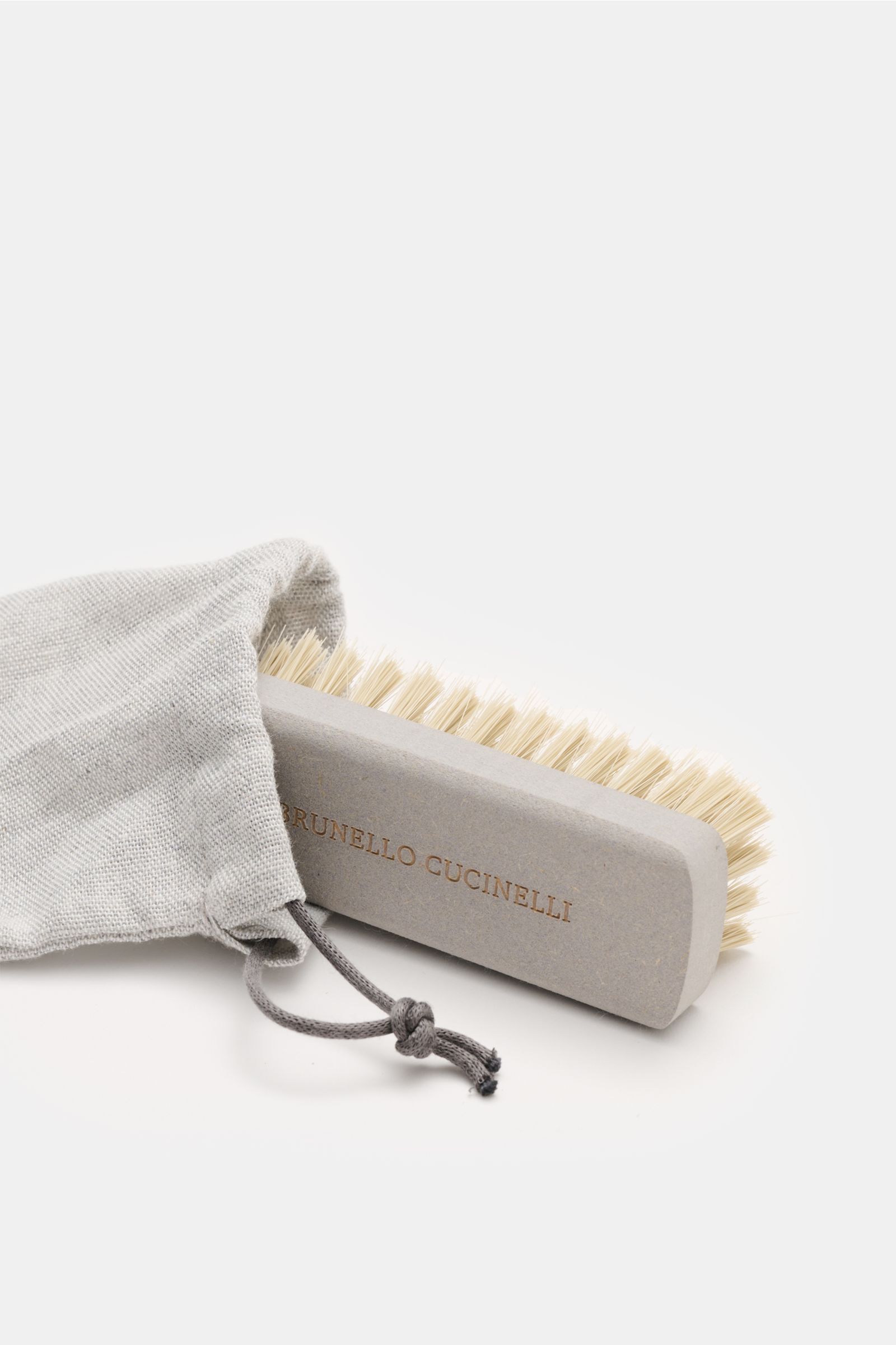 A front angled view of a Brunello Cucinelli Tassel Loafer dunkelbraun in soft velour leather, featuring a slim tapered silhouette, typical tassel, Goodyear welted construction, leather lining, and flexible leather sole, showcasing smart casual elegance wi