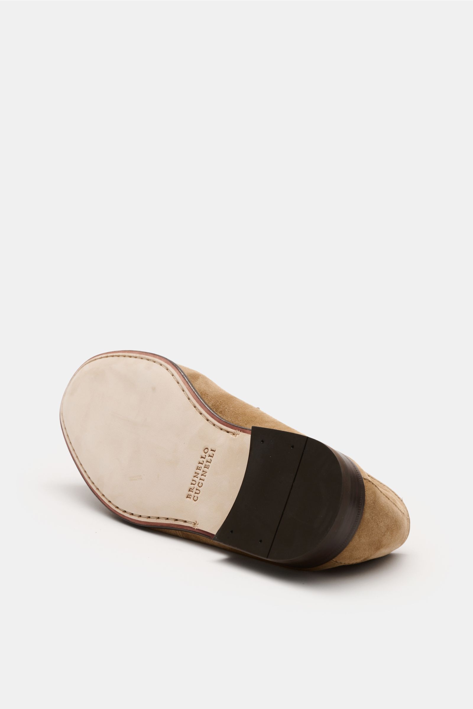 Bottom view of the Brunello Cucinelli Penny Loafer beige showcasing its smooth velour leather, Goodyear-welted sole, narrow shape, typical penny strap, leather lining, and flexible leather outsole, embodying stylish casualness.
