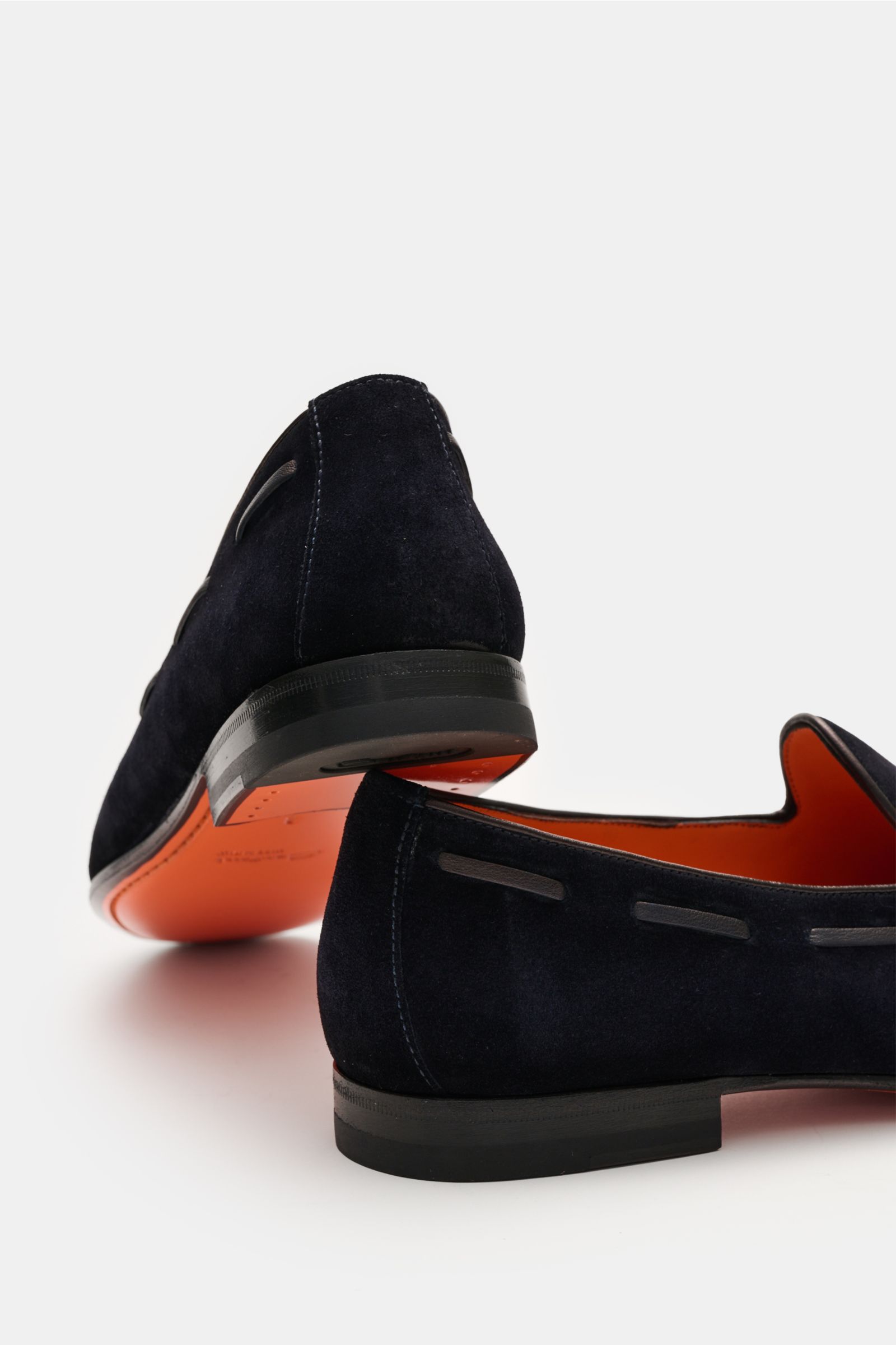 Santoni Tassel Loafer 'Carlos' navy in soft velour leather shown from rear and side angles, featuring slim silhouette, Goodyear welt, decorative front seam, typical tassel, leather lining, ultra-flexible leather sole, and rubber heel reinforcement. In gew