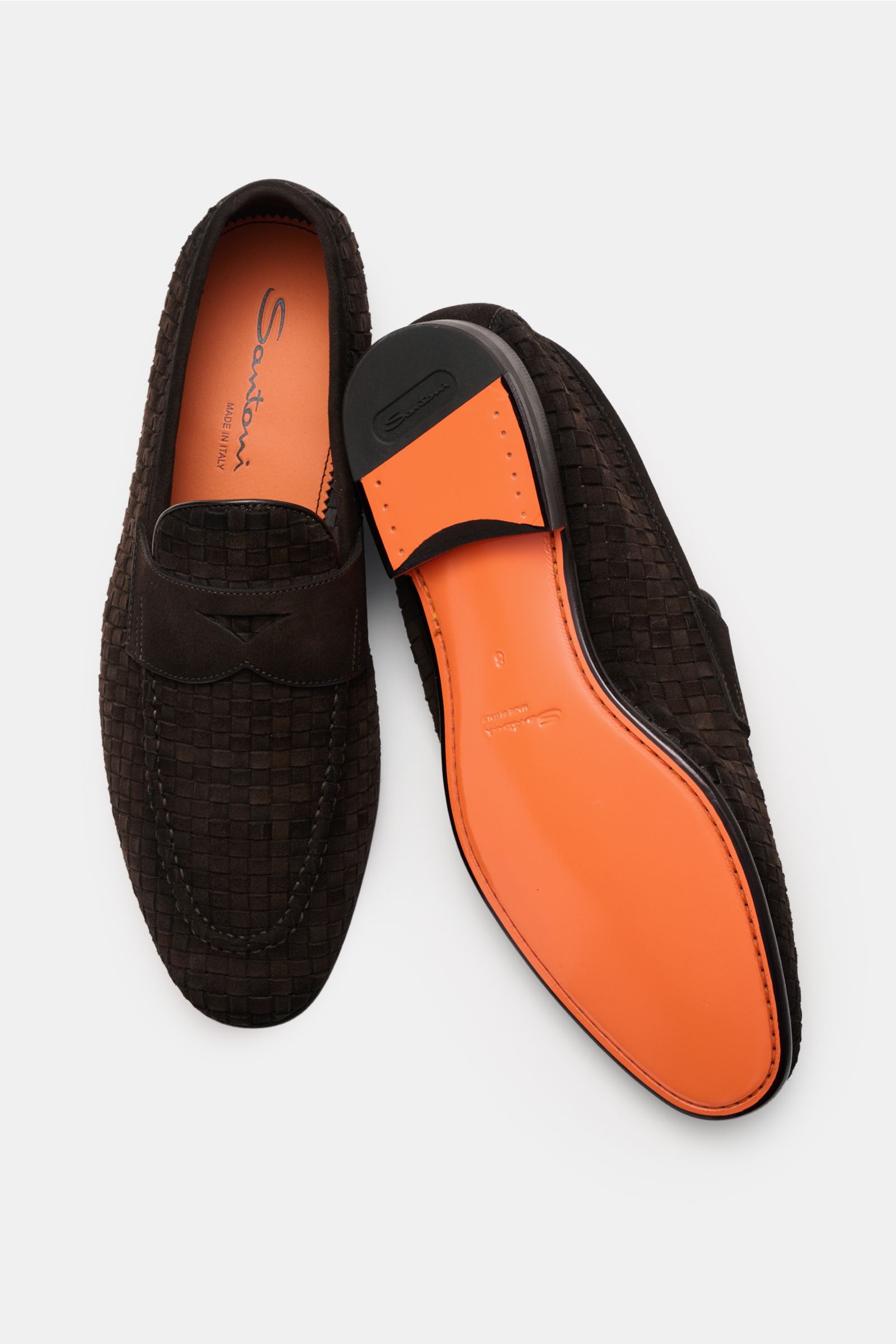 Top and sole view of Santoni Penny loafers 'Carlo' dark brown braided suede with tapered silhouette, toe cap stitching, and signature penny strap.

Perfect your sophisticated wardrobe with the penny loafers 'Carlo' by SANTONI made of braided suede with