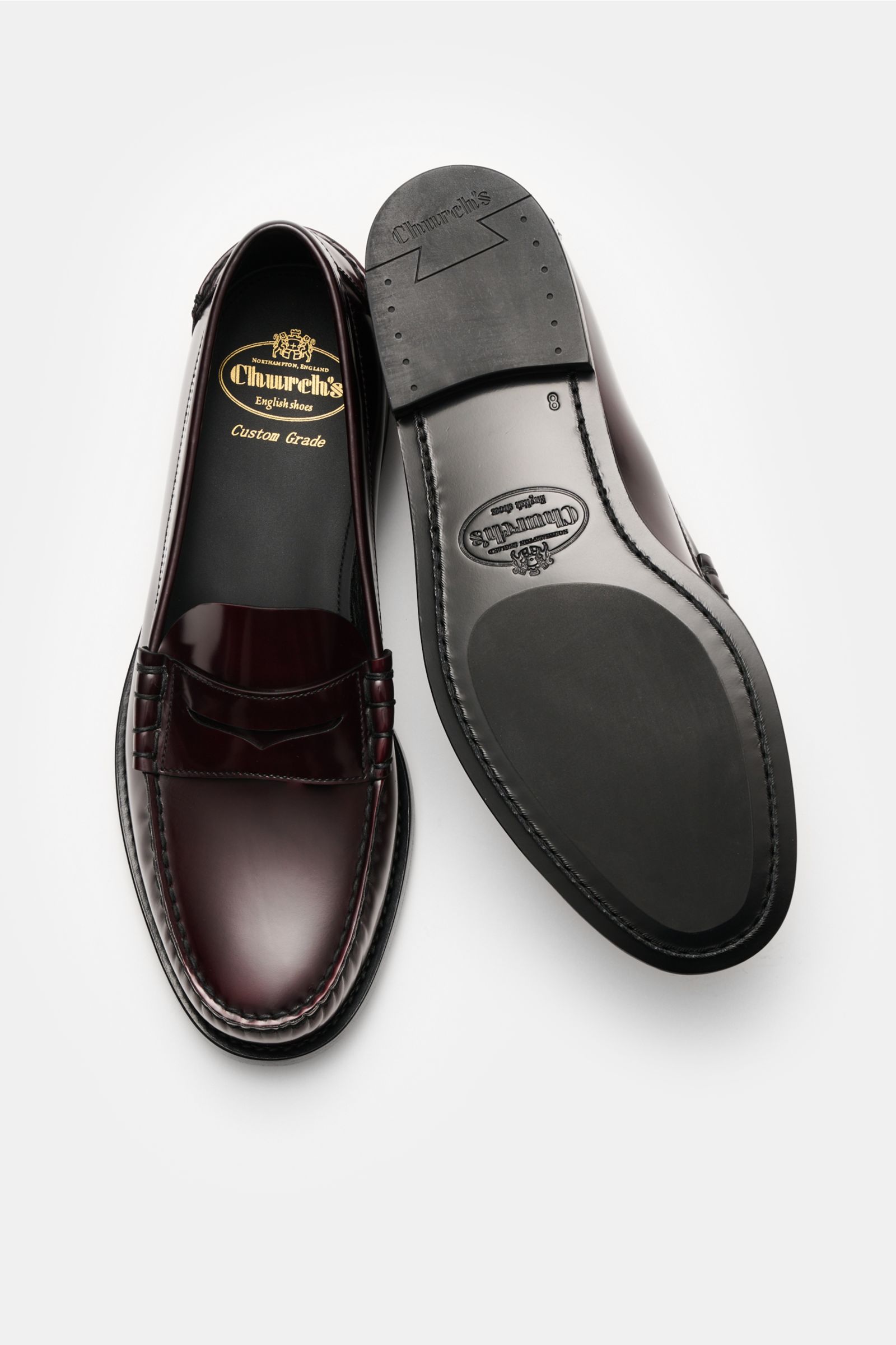 Church's Penny Loafer 'Rowley' bordeaux shown from top and sole view, polished smooth leather, Goodyear-welted, narrow silhouette, typical penny strap, decorative stitching, leather lining, leather sole, rubber-reinforced heel.