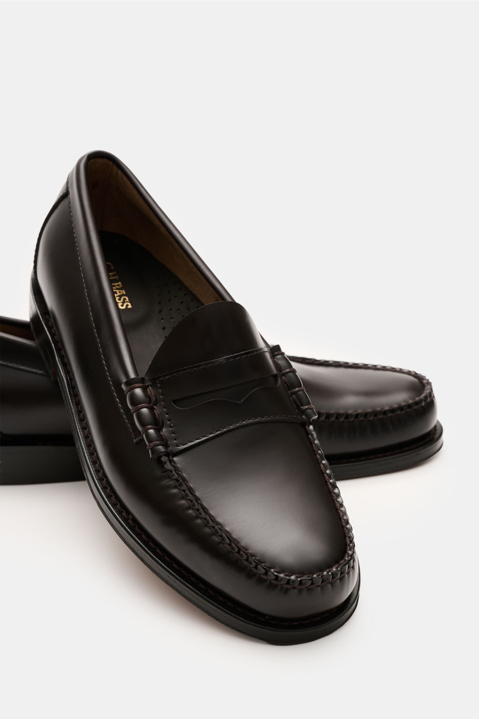 G.H.Bass Penny Loafer 'Weejuns Larson' dunkelbraun aus edlem Glattleder, schräg von vorne, mit Penny Strap, Zierschnürung und ledernem Innenfutter.