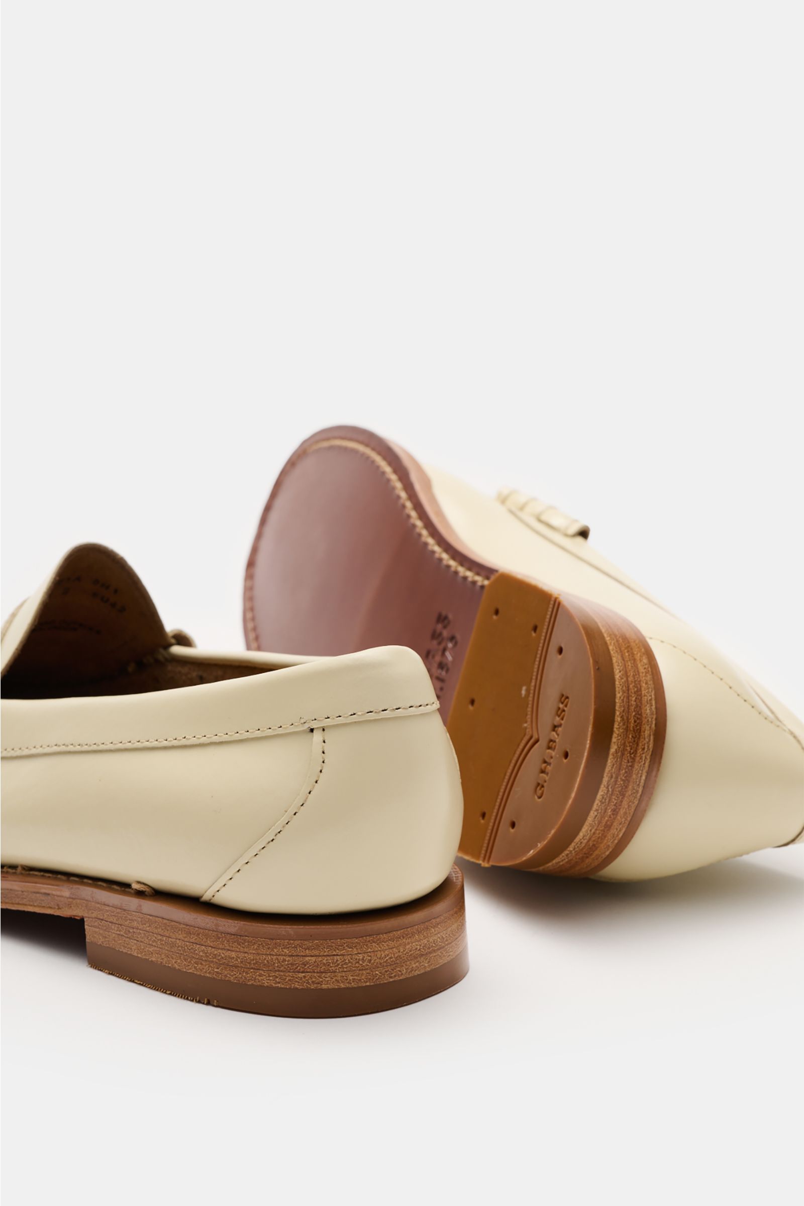 G.H.Bass Penny Loafer 'Weejuns Larson' creme shown from rear and sole perspective, featuring smooth leather, stitched construction, narrow silhouette, penny strap, decorative lacing, leather lining, comfortable footbed, leather sole, rubber-reinforced hee