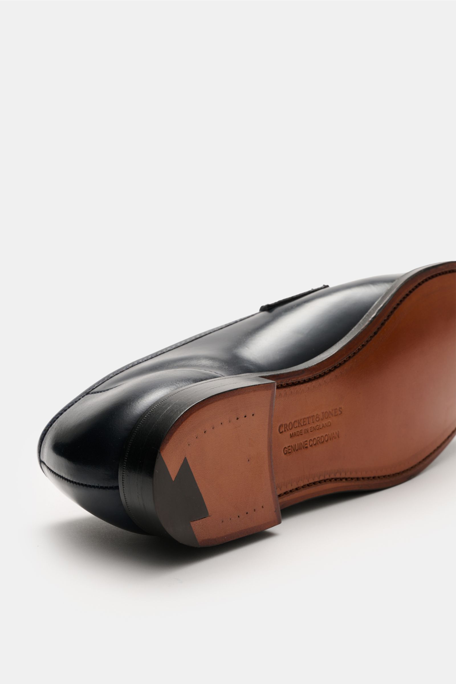 Crockett & Jones Penny Loafer 'Harvard' navy shown from sole side, polished smooth leather, slim silhouette, penny strap, stitched toe cap, leather outsole.