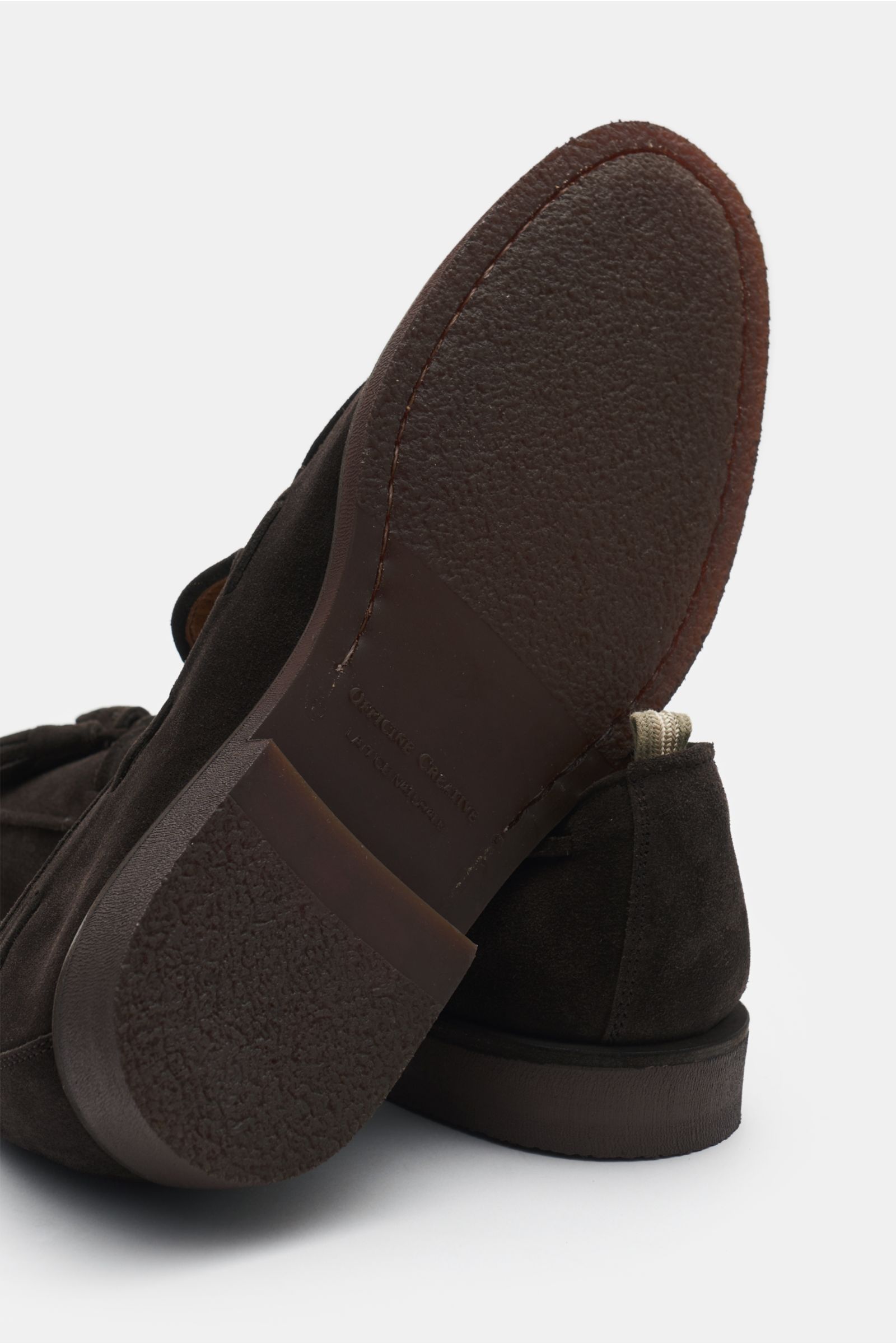 Officine Creative Tassel Loafer 'Opera Flexi 106' dunkelbraun shown from sole perspective, featuring soft suede, natural rubber sole, Goodyear welt, leather lining, tassel, and grosgrain pull tab for comfort and style.
