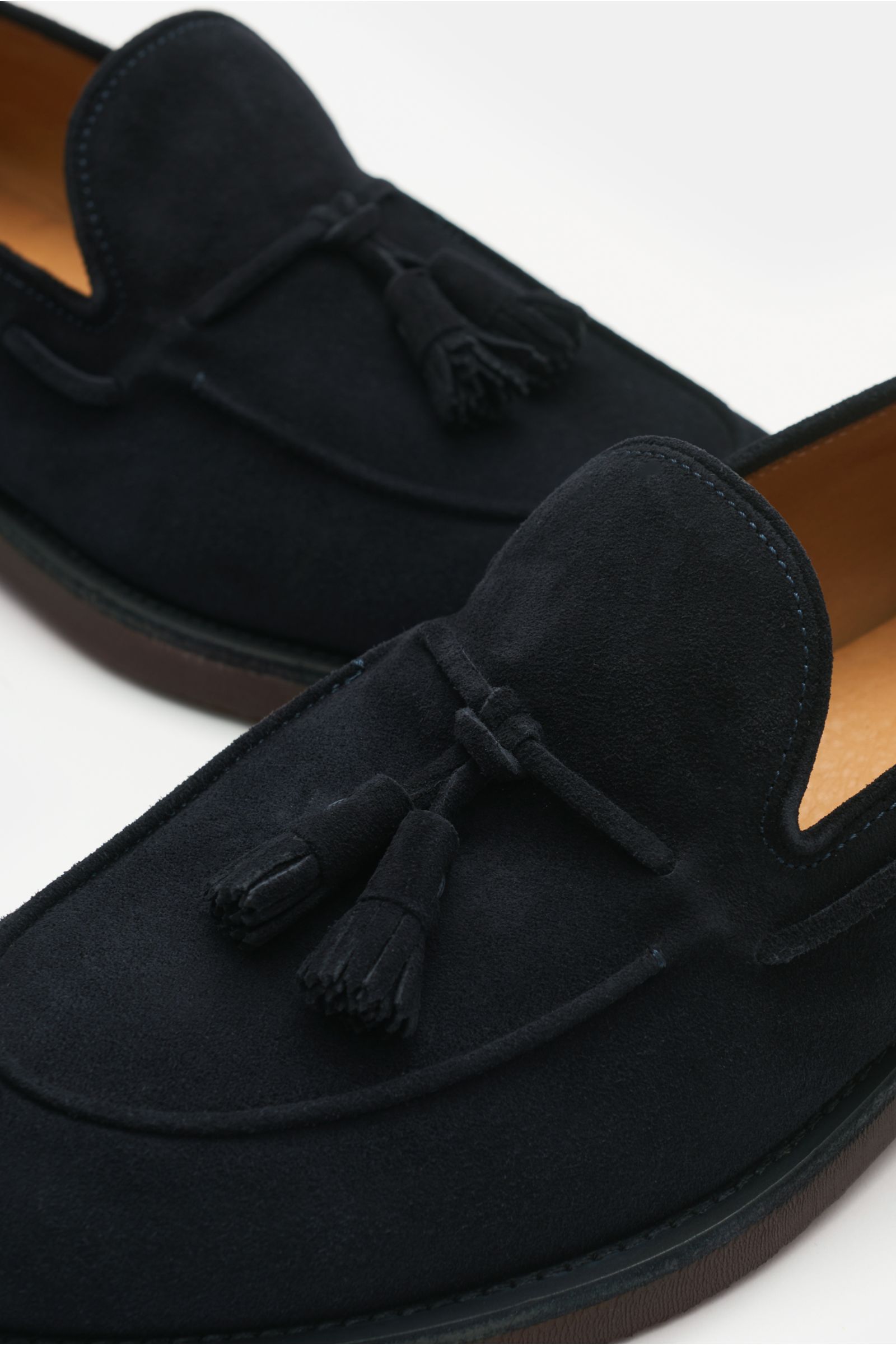 Close-up top angle view of the Officine Creative Tassel Loafer 'Opera Flexi 106' navy in supple suede with tassel detail, soft finish, slim silhouette, Goodyear-welted, grosgrain pull tab, leather lining, and natural rubber sole for unmatched comfort.