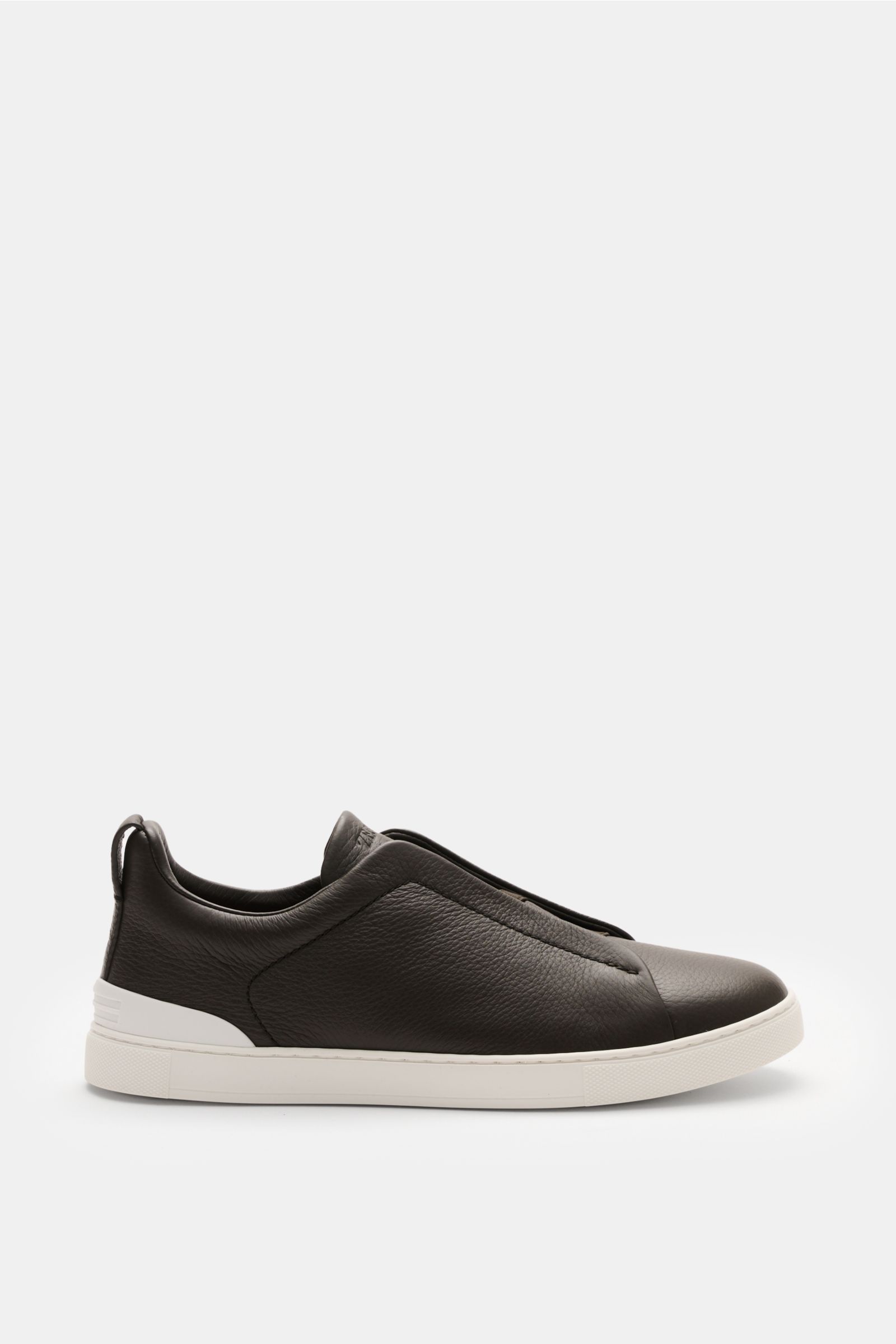 Side view of Zegna Slip-on-Sneaker 'Triple Stitch' navy in grained smooth leather with round toe, elastic cross bands, padded collar, pull loop, ZEGNA embossed tongue, leather lining, and flexible white rubber sole, designed for comfort and ease. Reinschl