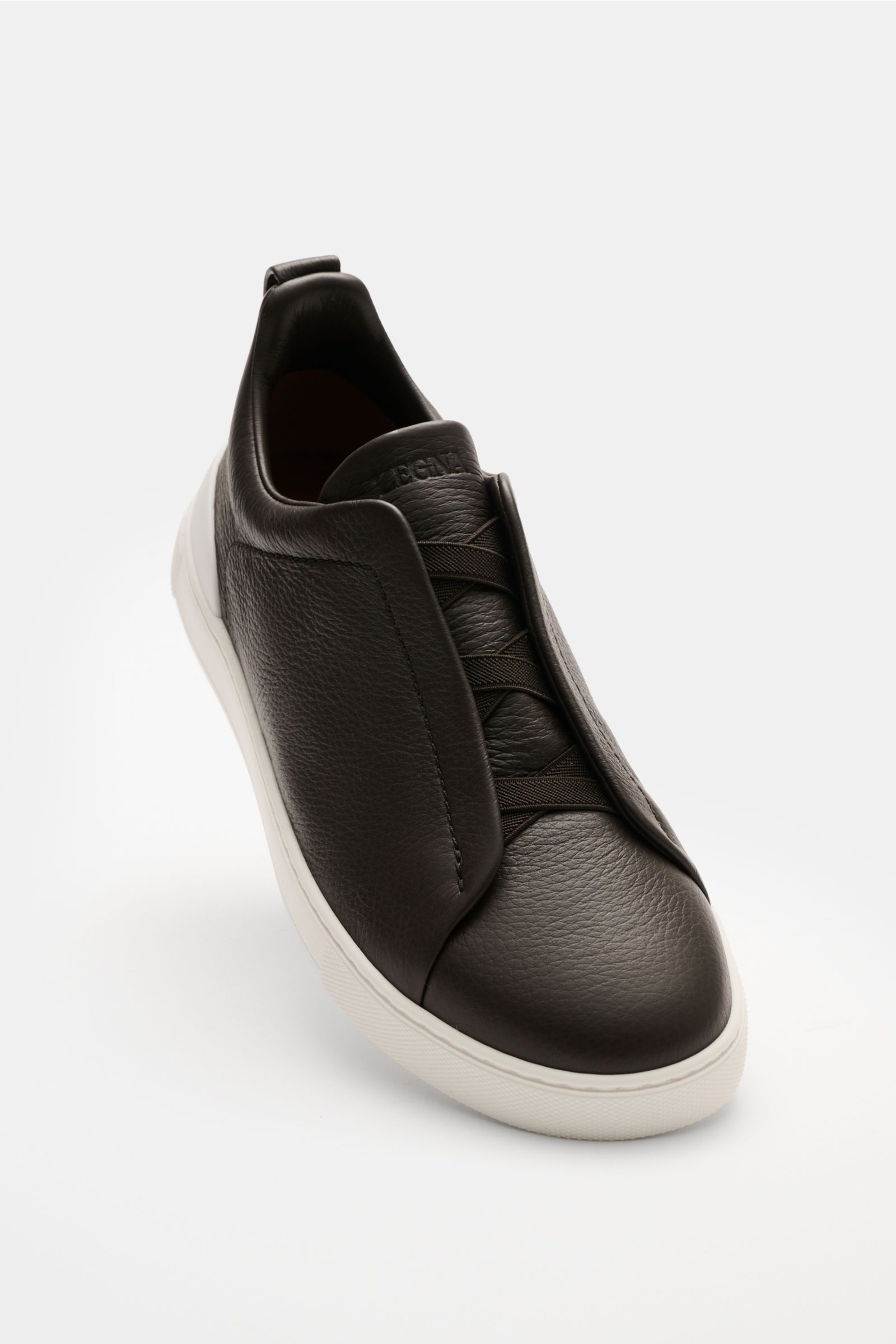 Front-side view of Zegna Slip-on-Sneaker 'Triple Stitch' navy in grained smooth leather with round toe, elastic bands, padded collar, pull loop, ZEGNA embossed tongue, leather lining, and flexible white rubber sole. Reinschlüpfen und wohlfühlen – nichts t