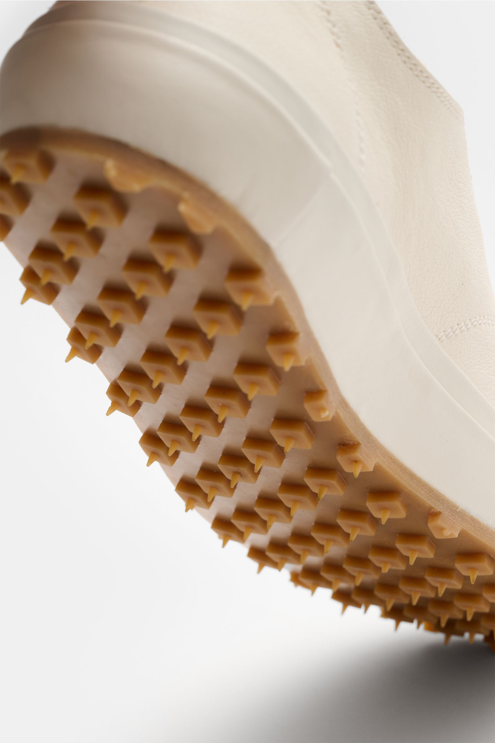 Close-up low-angle view of the Officine Creative Sneaker 'Vulcan' offwhite showing the finely grained leather upper and studded rubber sole. Modern retro look with round toe cap, seven-eyelet lacing, logo-embossed tongue, leather lining, and nubby rubber 