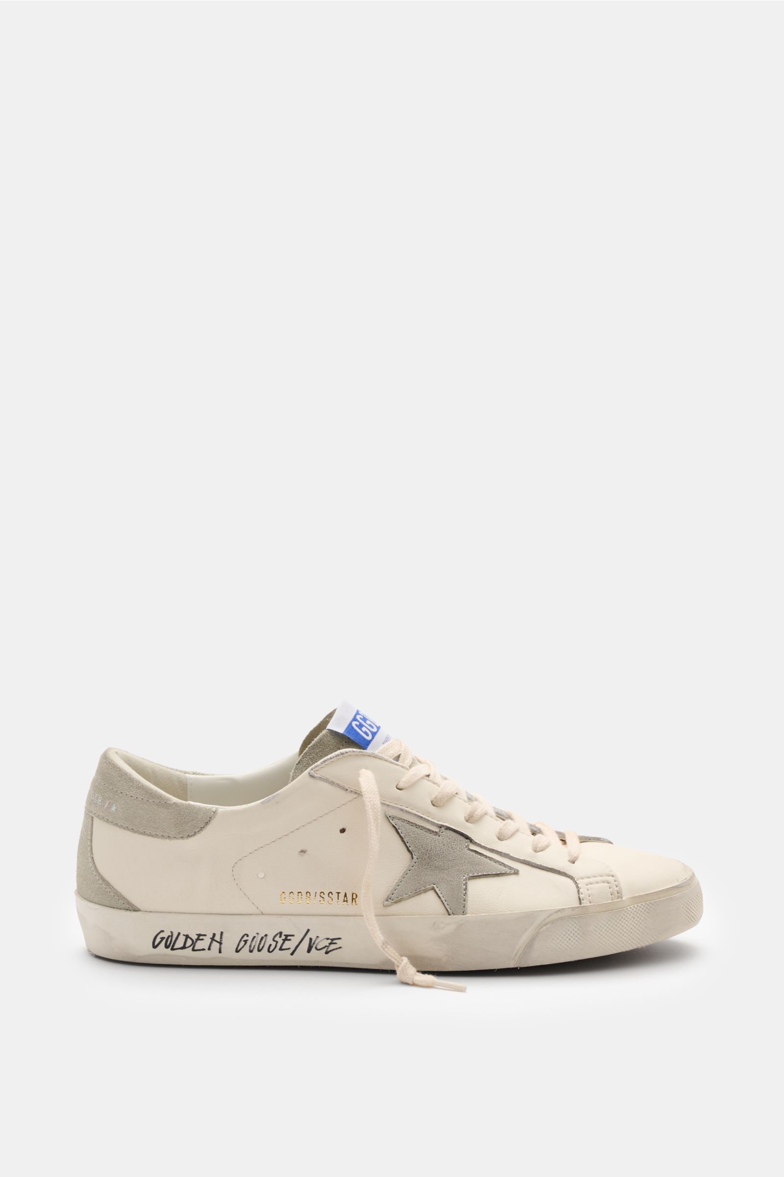 Side view of Golden Goose Sneakers 'Super-Star Classic' off-white/light grey with vintage finish, star patch, suede overlays, and handwritten sole text.