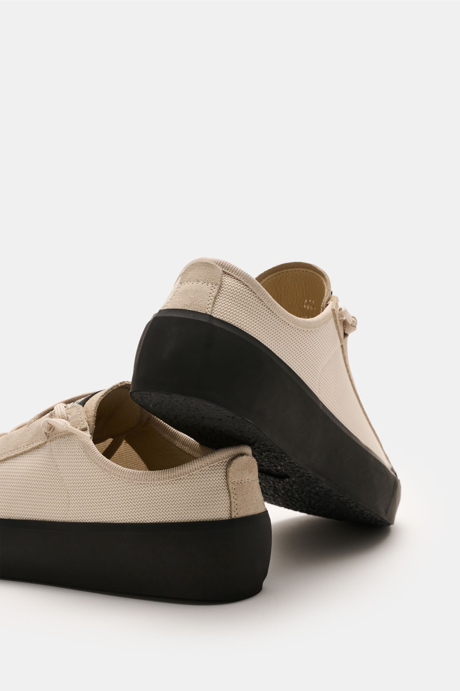 Stone Island Sneaker beige shown from a rear low angle, featuring beige mesh, suede, seven-hole lacing, rubber sole, logo patch, leather lining.