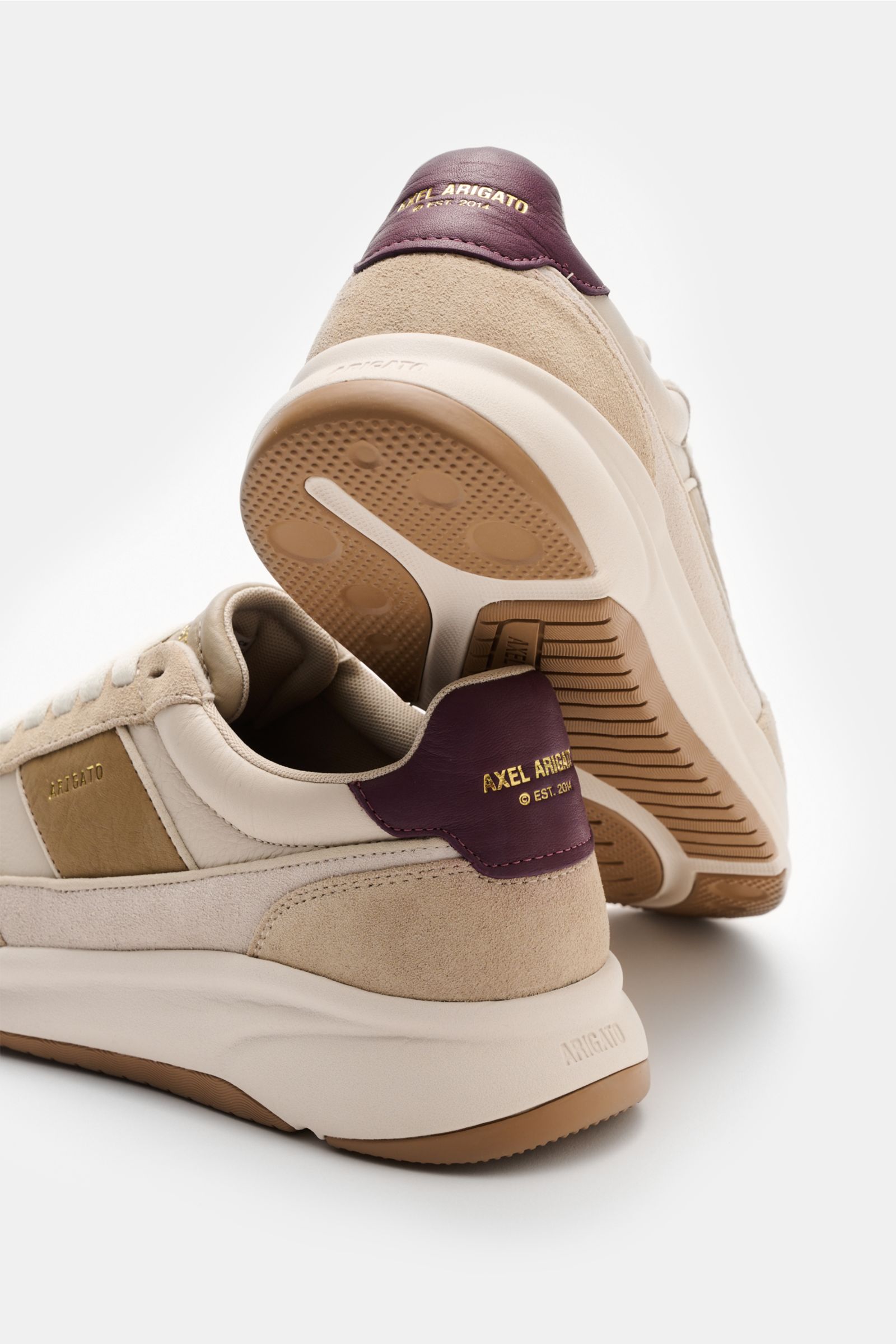 Rear and side view of Axel Arigato Sneaker 'Genesis Neo Runner' sand/beige showing high-quality velour and smooth leather, tonal overlays, perforated rounded toe, seven-hole lacing, gold label embossing, padded collar, leather lining, and flexible rubber 