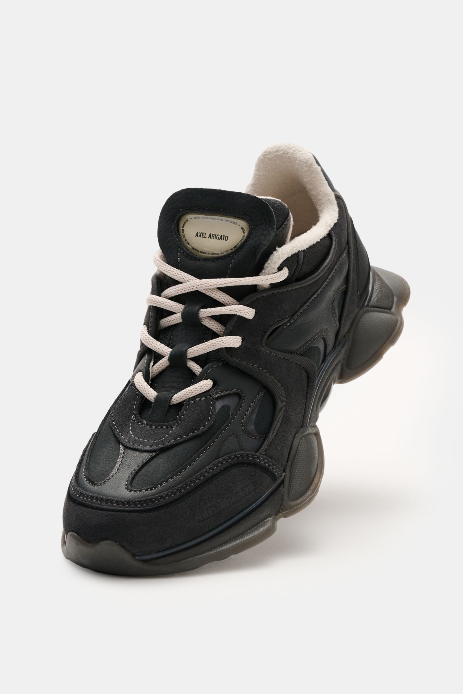 Front angled view of Axel Arigato Sneaker 'Eris' schwarz in black with elegant suede leather, overlays in suede and smooth leather, slim silhouette, four-hole lacing, logo patch on tongue, textile lining, and rubber sole. For trendy spring styles, the sne