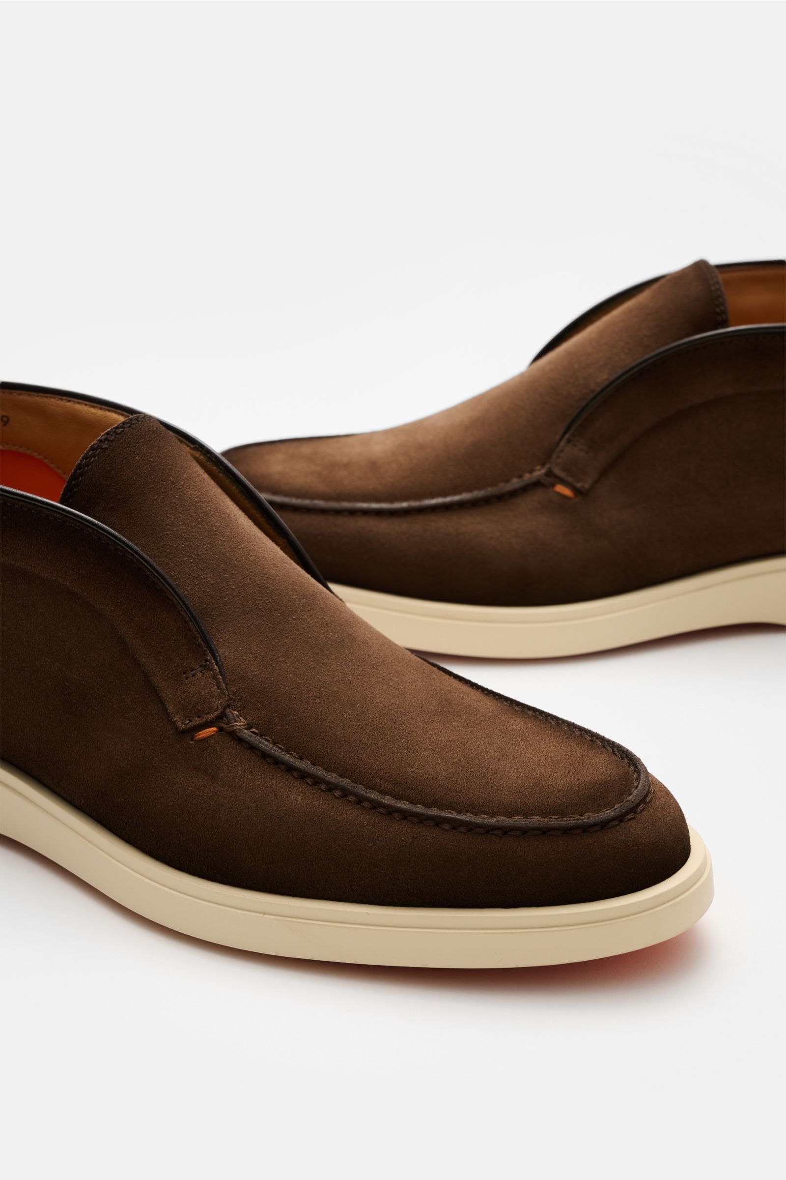 Close-up view of Santoni Desert Boot 'Detroit' braun in smooth brown velour leather with slim silhouette, contrast stitching, and flexible white rubber sole.

Desert Boot aus geschmeidigem Veloursleder von SANTONI: Die flexible Gummisohle im Sneaker-St