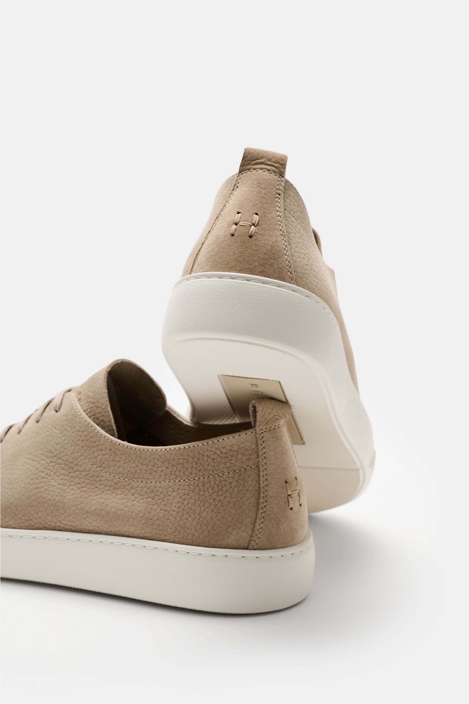 Rear and side view of Henderson Sneaker 'Thomas' taupe in soft brushed leather with round toe, seven-hole lacing, logo embossing, leather lining, pull tabs, and light rubber sole.