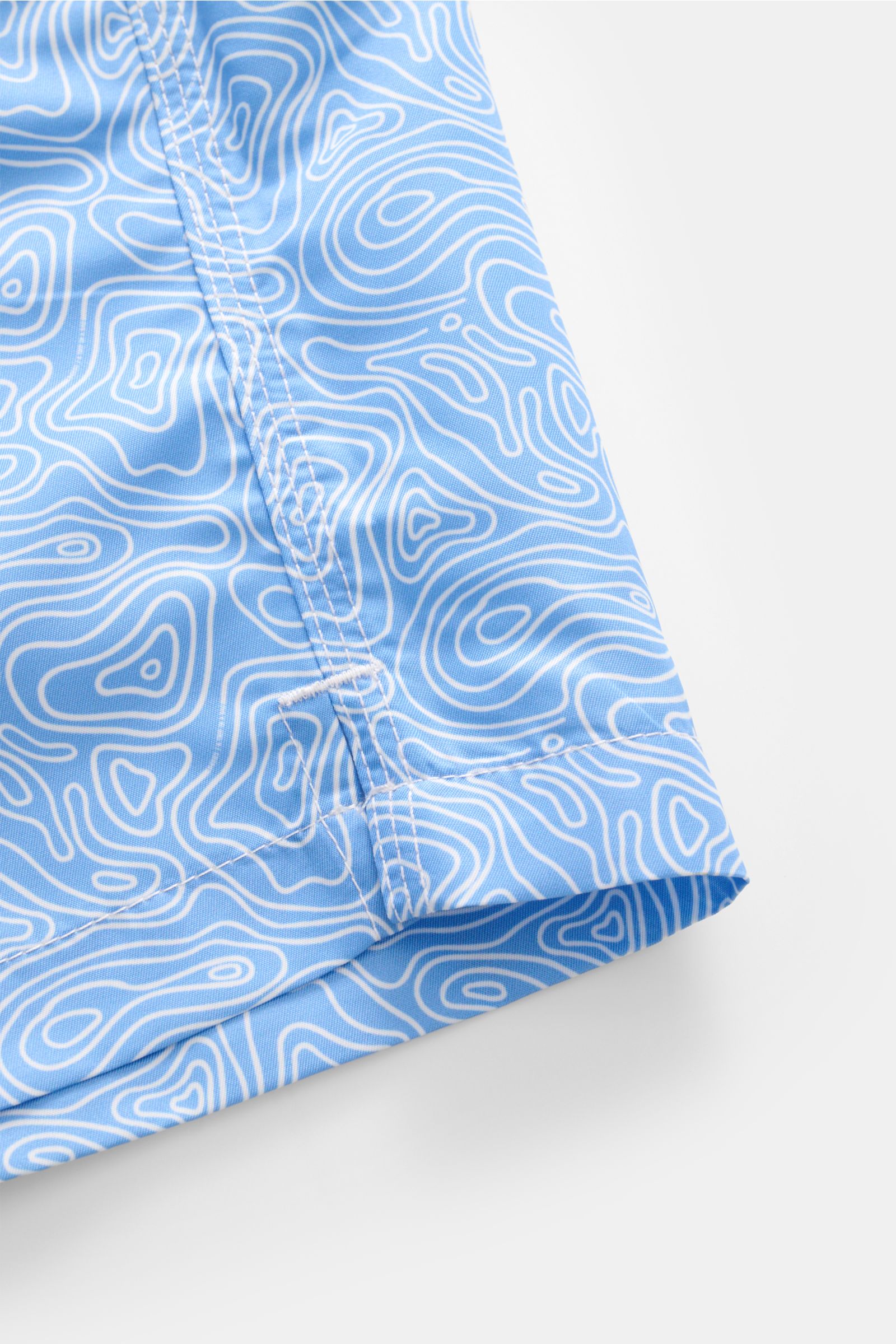 Close-up side view of 04651/ A trip in a bag Badeshorts 'Seamap' blau/weiß gemustert with quick-drying microfiber and small hem slit.