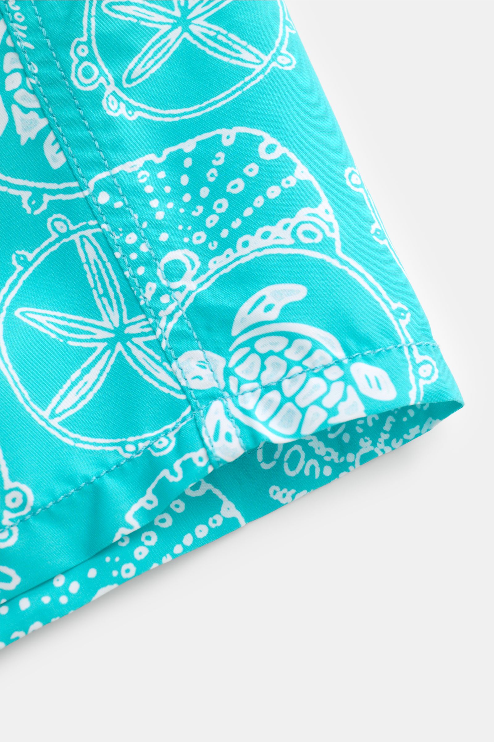 Vilebrequin Swim shorts 'Moorea' turquoise/white patterned, close-up side view showing high-quality microfibre fabric with sea turtle and starfish print.