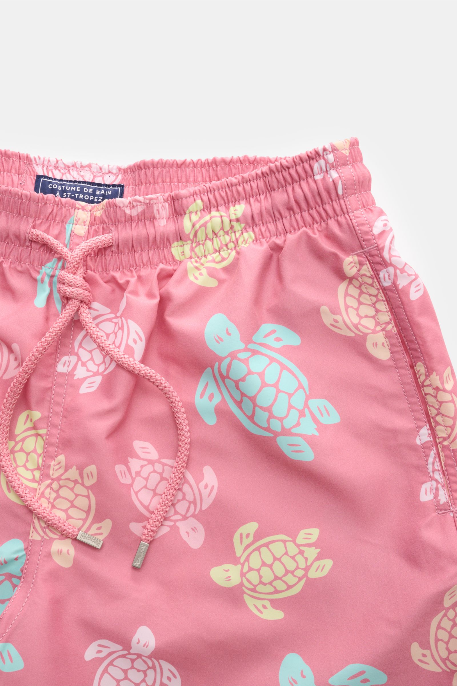 Vilebrequin Swim shorts 'Moorea' rose/mint/yellow patterned, close-up front view showing elasticated waistband, drawstring, and turtle print design.