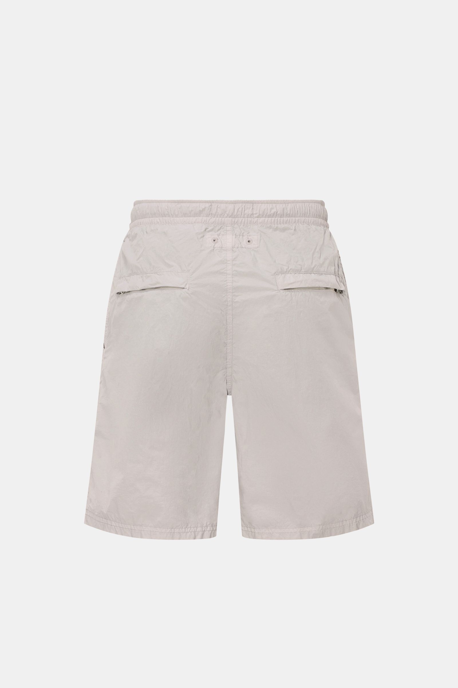 Stone Island Swim shorts 'Ghost Piece' grey shown from the back, featuring elastic waistband, zippered back and side pockets, regular fit.  
A monochrome look in classic STONE ISLAND style: on the beach or at the pool, these swim shorts from the 'Ghost