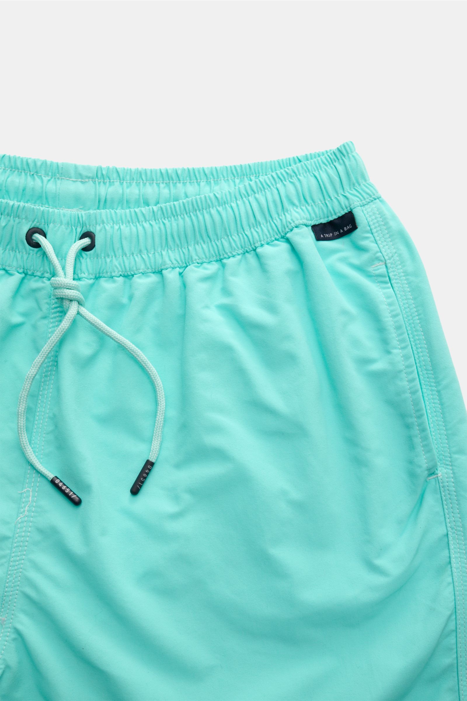 04651/ A trip in a bag Badeshorts 'Plain Swim' türkis, Detailaufnahme von oben, schnelltrocknende Microfaser, Bund mit Tunnelzug, Taschen, Kontrast-Stitching.