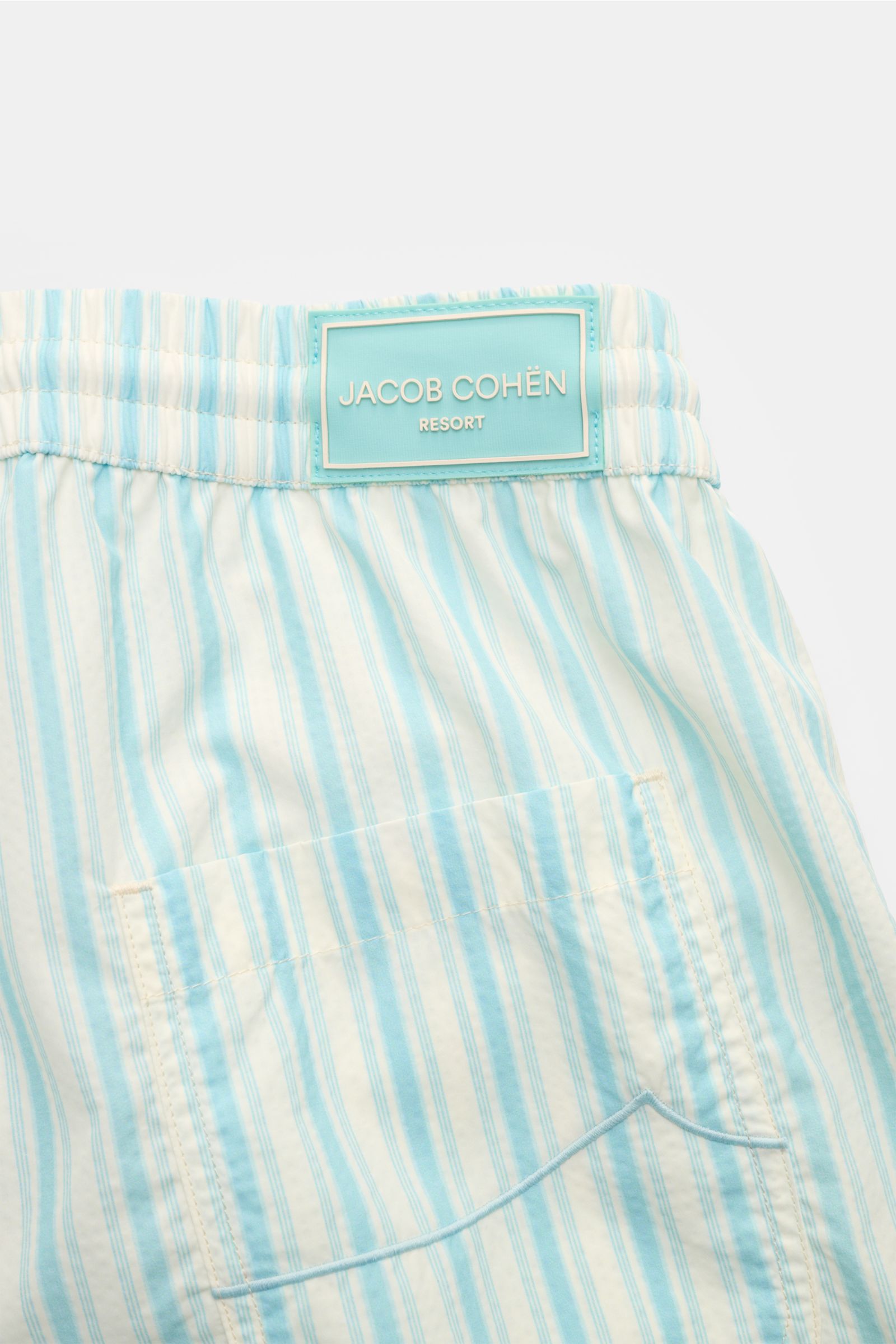 Jacob Cohen Swim shorts light blue/white striped shown from the back top view, featuring elasticated waistband with drawstring, patch pocket.

Description: Perfect for sunny days: These swim shorts by JACOB COHEN combine flowing material with a classic
