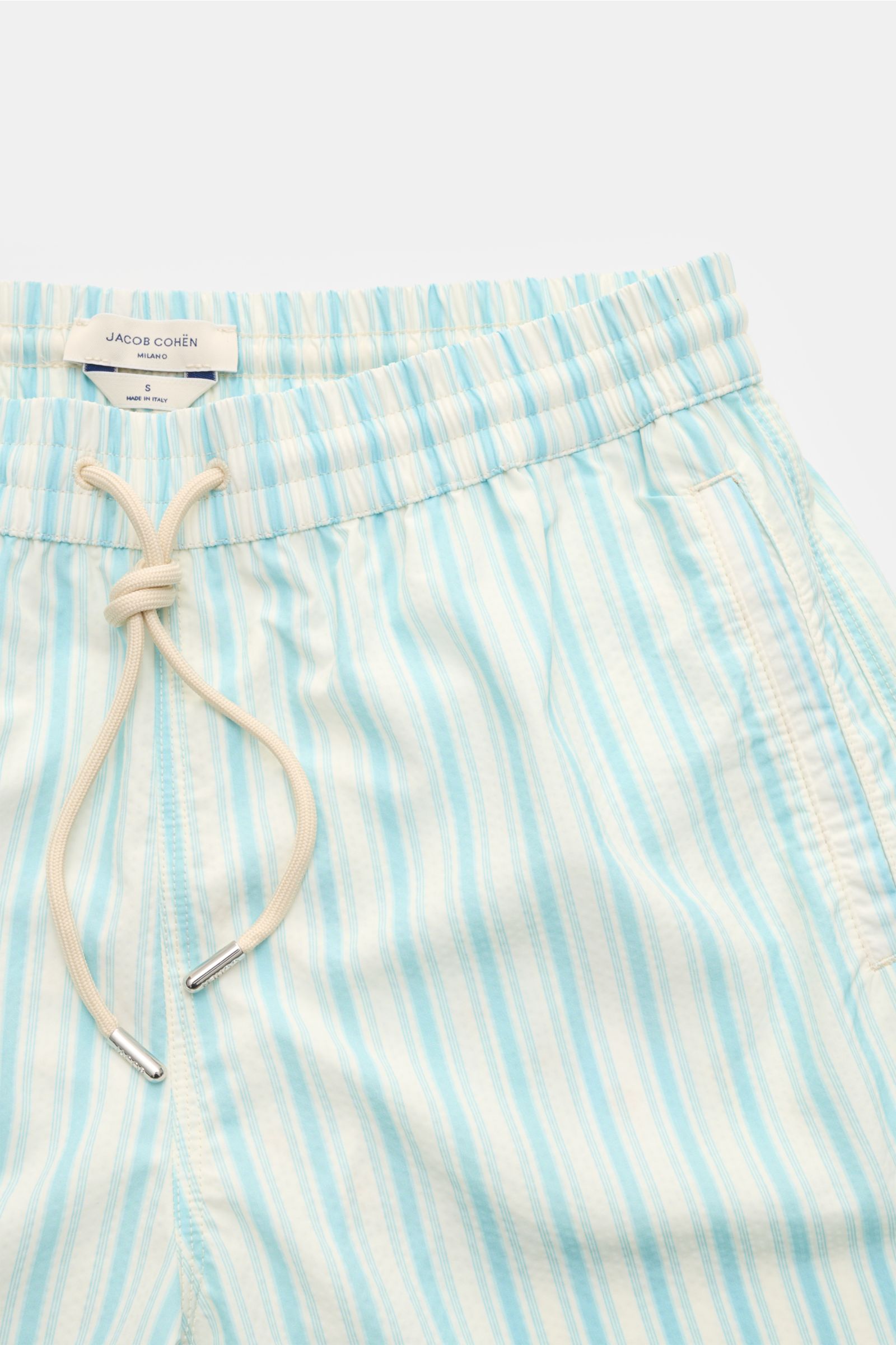 Close-up front view of Jacob Cohen Swim shorts light blue/white striped, showing elasticated waistband, drawstring, and pocket details.

Perfect for sunny days: These swim shorts by JACOB COHEN combine flowing material with a classic striped design.