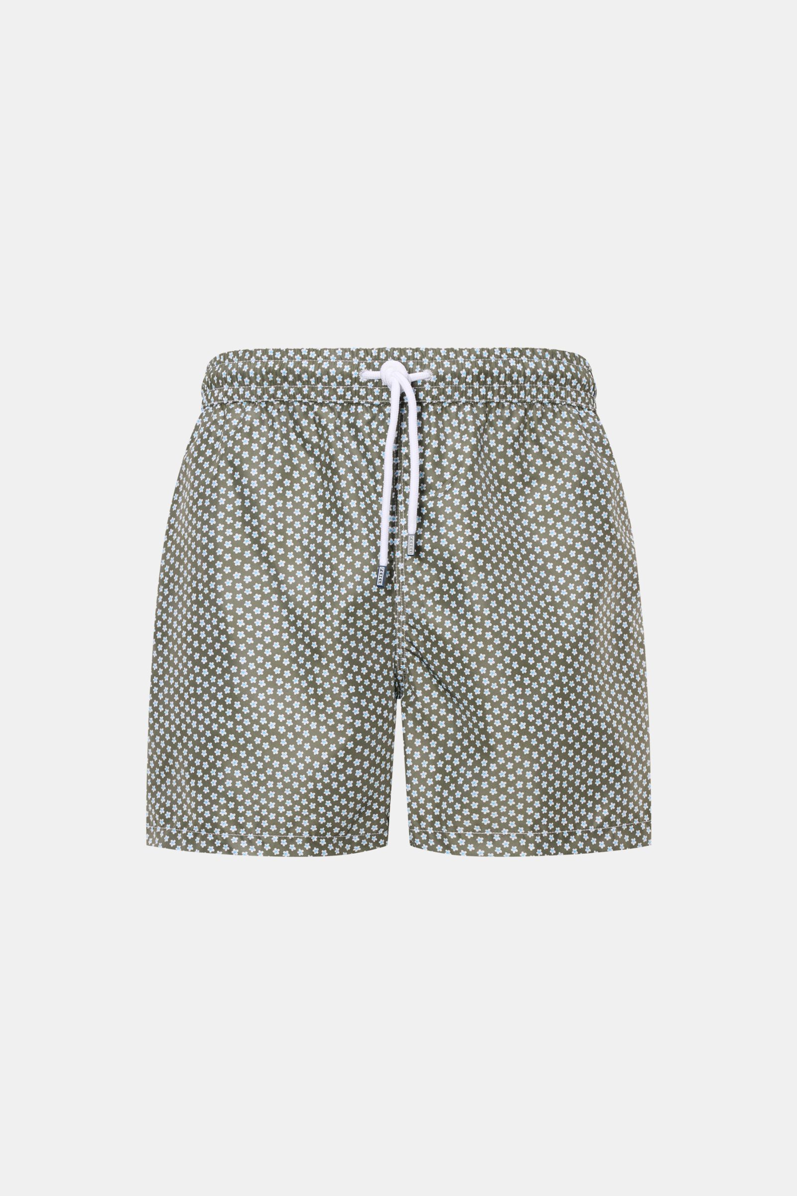 Front view of Fedeli Swim shorts 'Madeira Airstop' green/white/light blue patterned with floral design, elastic waistband, and white drawstring.

Description: An essential for your summer vacation: These FEDELI swim shorts have an expressive pattern that 