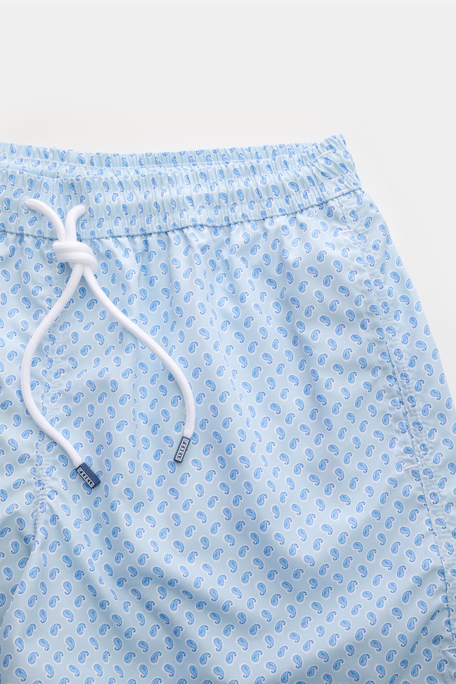 Fedeli Badeshorts 'Madeira Airstop' hellblau/weiß/blau gemustert, Paisleymuster, elastischer Bund mit Tunnelzug, seitliche Taschen, Detailaufnahme von oben.