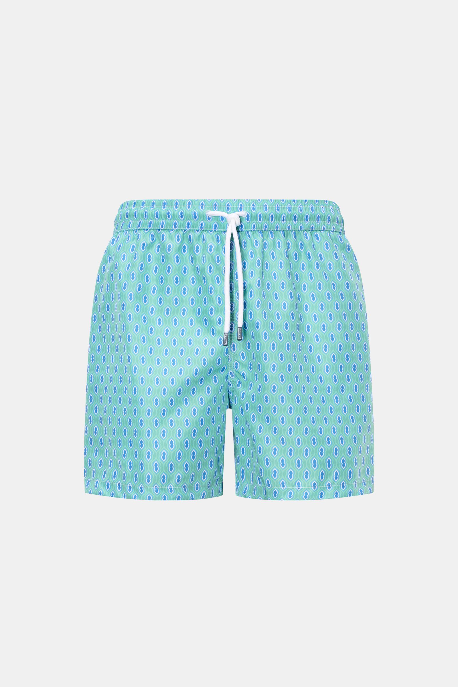 Front view of Fedeli Swim shorts 'Madeira Airstop' turquoise/blue/white patterned with elasticated waistband and white drawstring.

Description: An essential for your summer vacation: These FEDELI swim shorts have an expressive pattern that adds stylish a