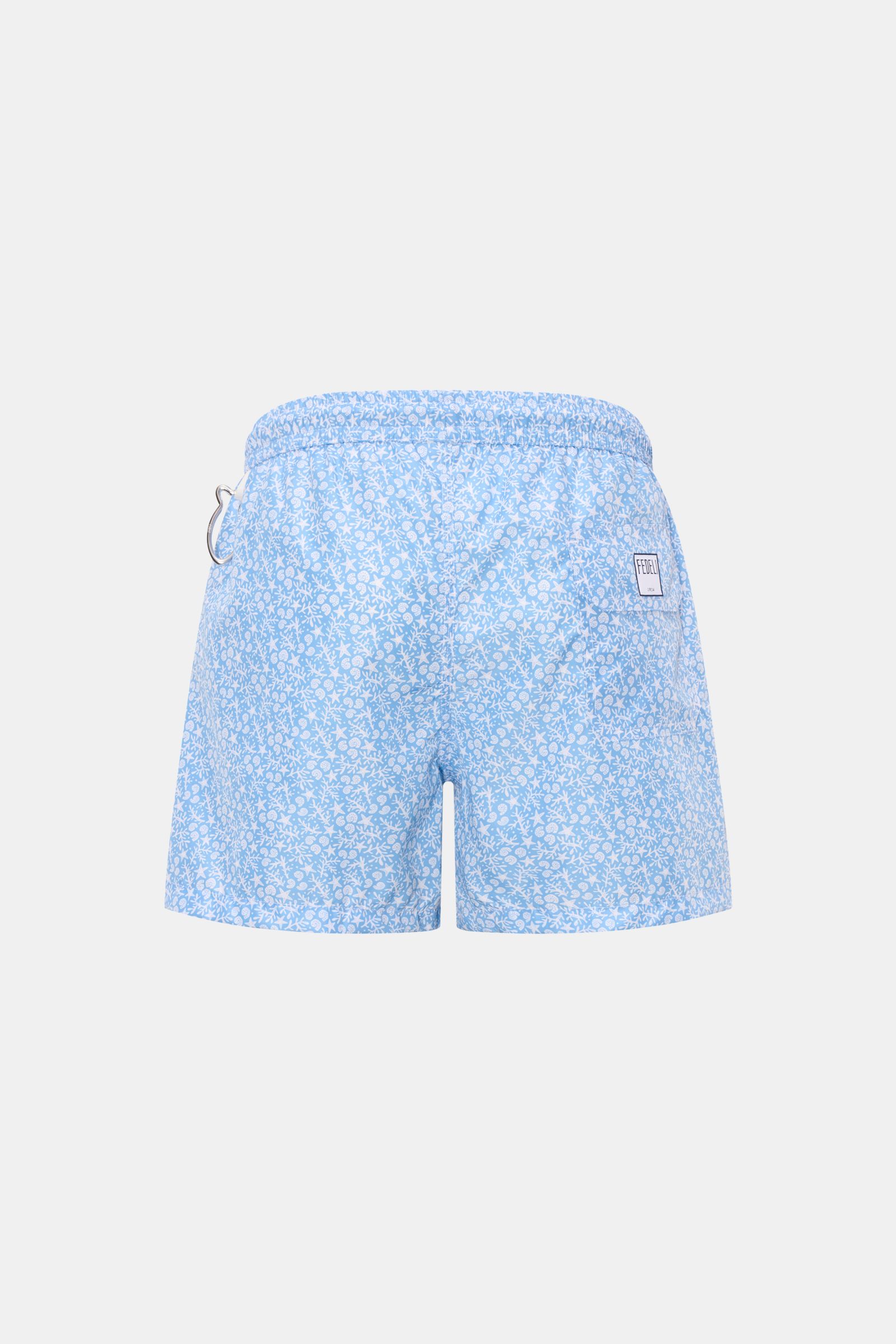 Rear view of Fedeli Swim shorts 'Madeira Airstop' light blue/white patterned with elasticated waistband, side pockets, back pocket, whale-shaped carabiner.

An essential for your summer vacation: These FEDELI swim shorts have an expressive pattern that