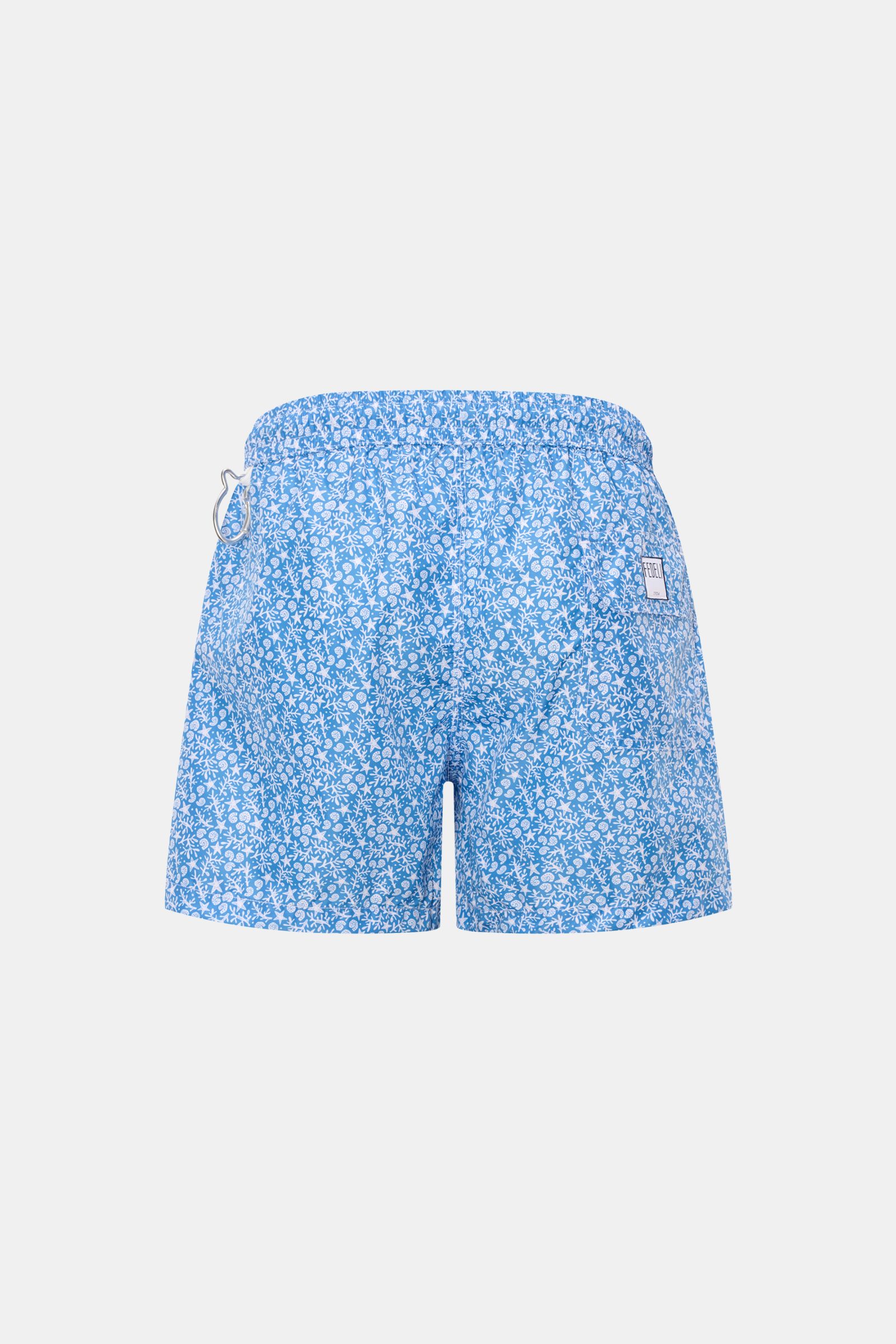 Rear view of Fedeli Swim shorts 'Madeira Airstop' blue/white patterned with elastic waistband, side vents, and whale-shaped carabiner.

An essential for your summer vacation: These FEDELI swim shorts have an expressive pattern that adds stylish accents