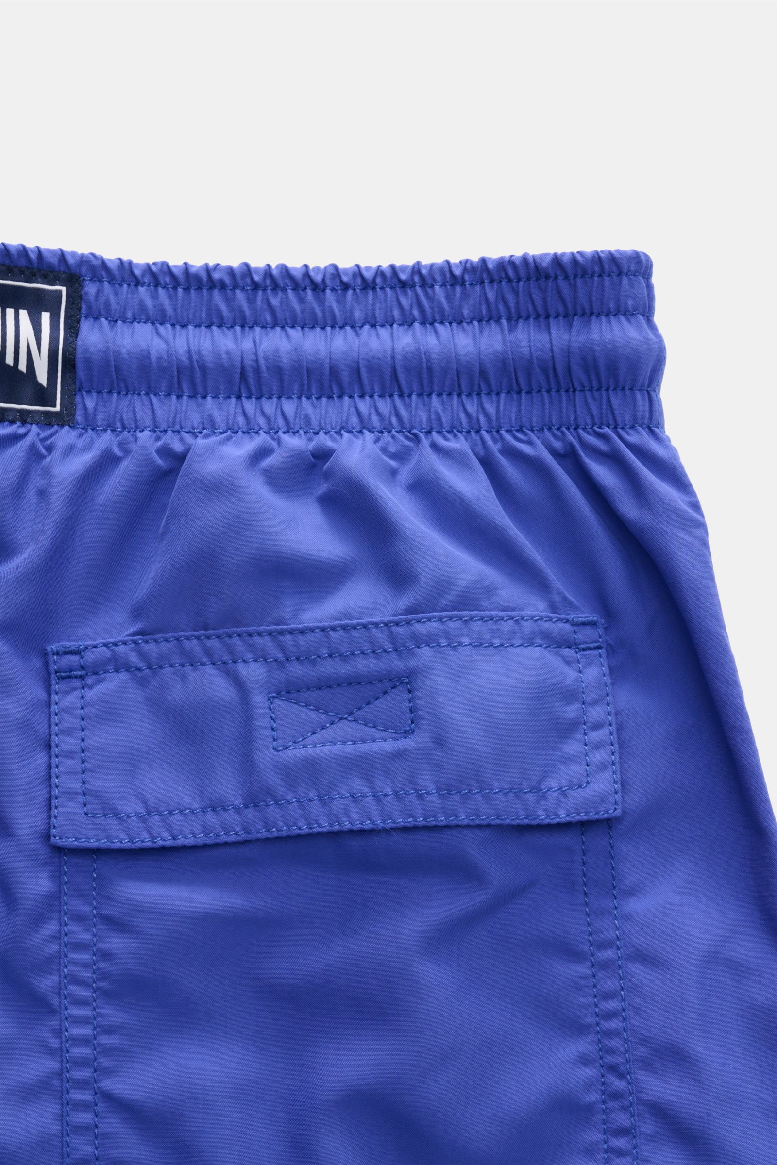 Close-up back view of Vilebrequin Swim shorts 'Moorea' blue, showing elasticated waistband, back pocket with hook-and-loop fastener, made of high-quality microfibre for comfort and freedom. Summer, sun, freedom: The 'Moorea' swim shorts by VILEBREQUIN are