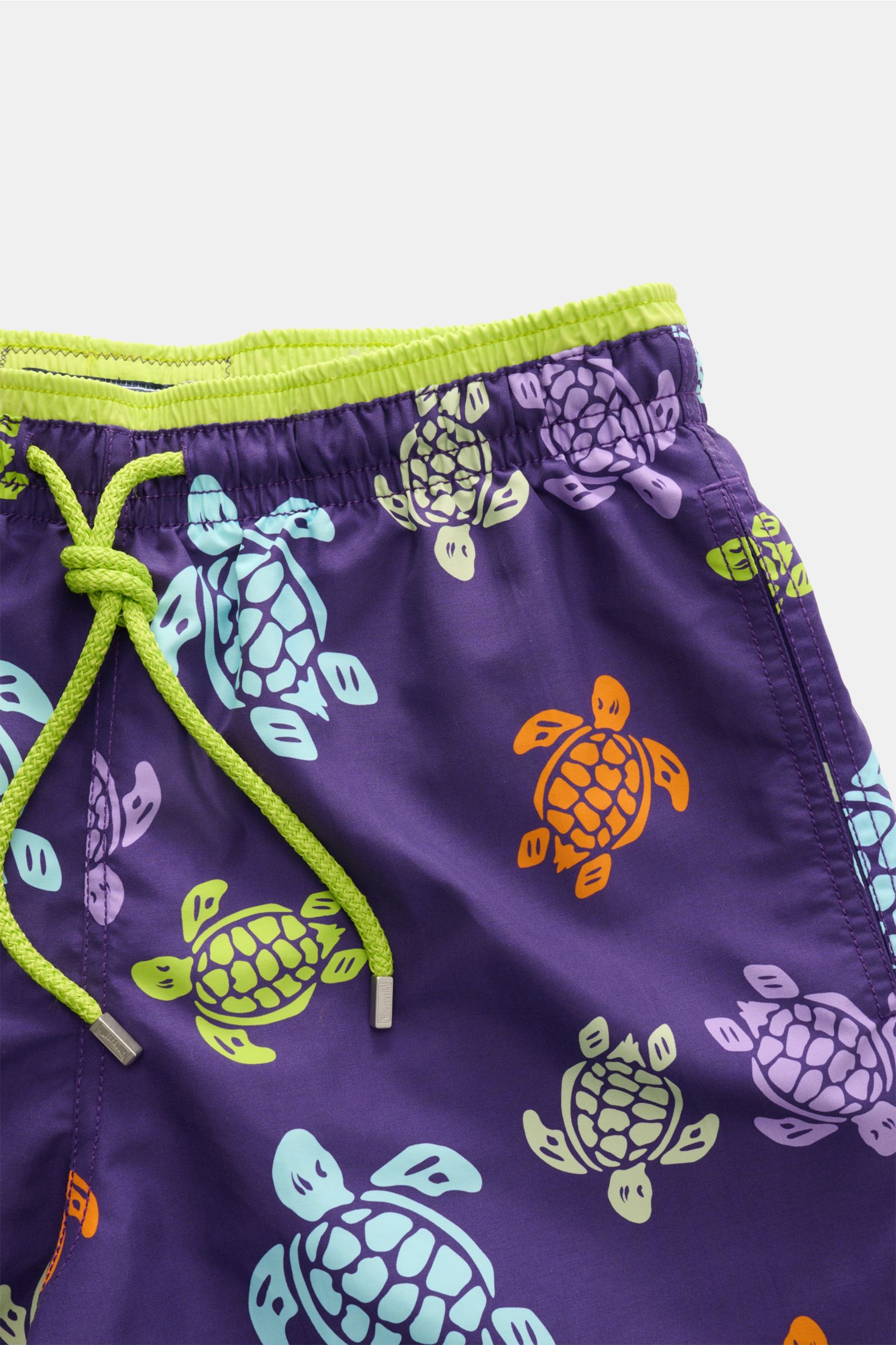 Vilebrequin Swim shorts 'Moka' purple/multi-coloured patterned, close-up front view showing elasticated lime green waistband, drawstring, and turtle print, made from high-quality microfibre with a pleasant light touch, regular fit, side pockets, back pock