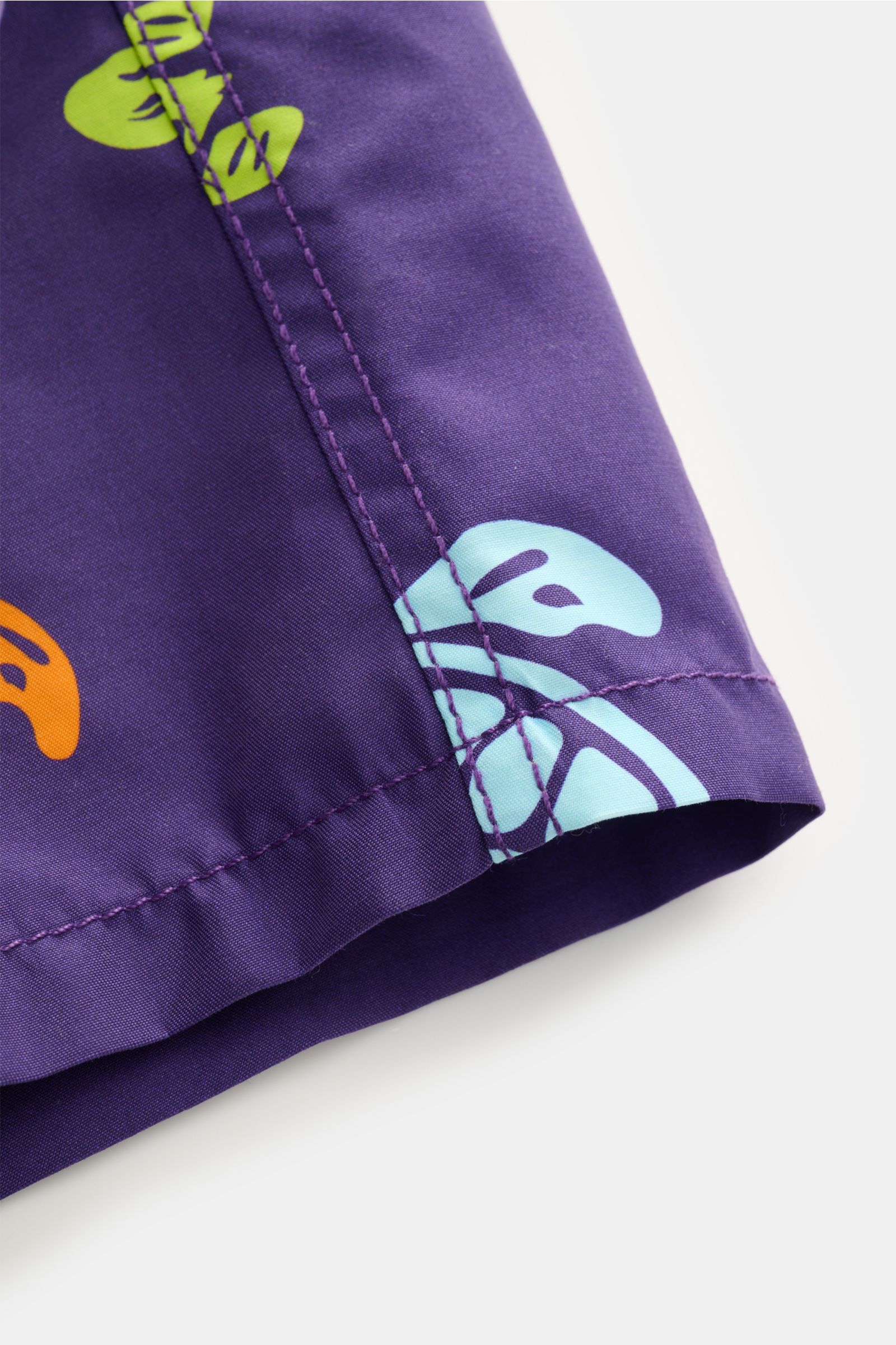 Close-up side view of Vilebrequin Swim shorts 'Moka' purple/multi-coloured patterned, showing high-quality microfibre fabric and stitching.