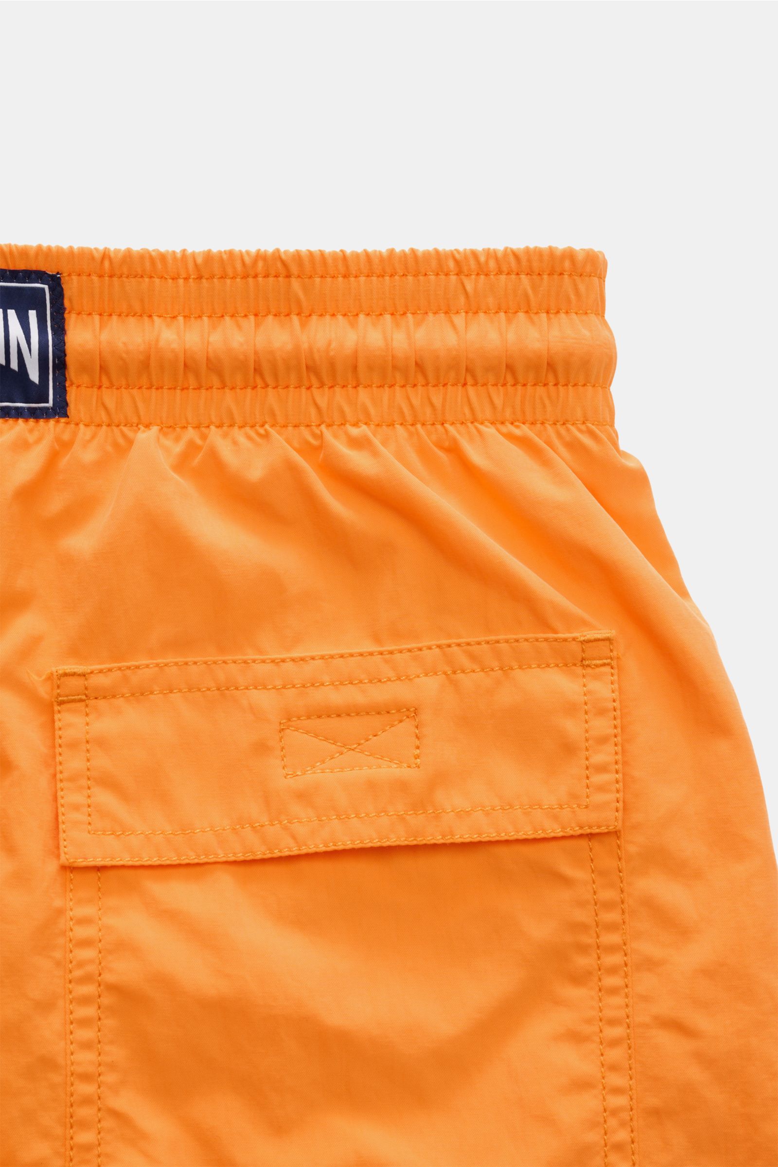 Vilebrequin Swim shorts 'Moorea Magic' orange shown from the back waist, made of high-quality microfibre that changes color in water, featuring an elasticated waistband with drawstring, side pockets, back pocket with hook-and-loop fastener, drainage eyele