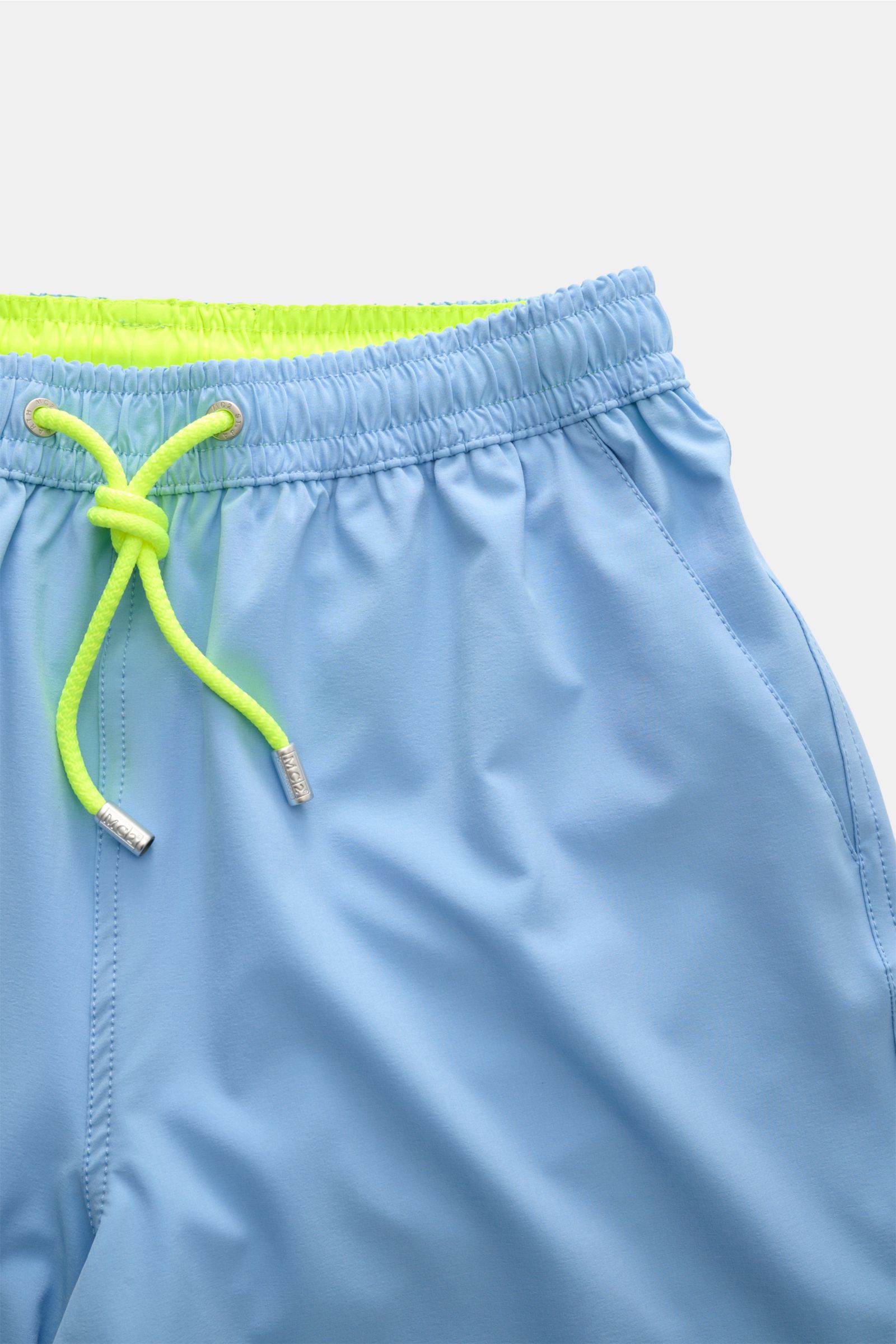 Close-up front view of MC2 Saint Barth Badeshorts 'Comfort' hellblau with neon yellow drawstring and elastic waistband.

Tauchen Sie ein in die erfrischende Welt von MC2 SAINT BARTH: Die Badeshorts 'Comfort' aus leichter, schnell trocknender Microfaser