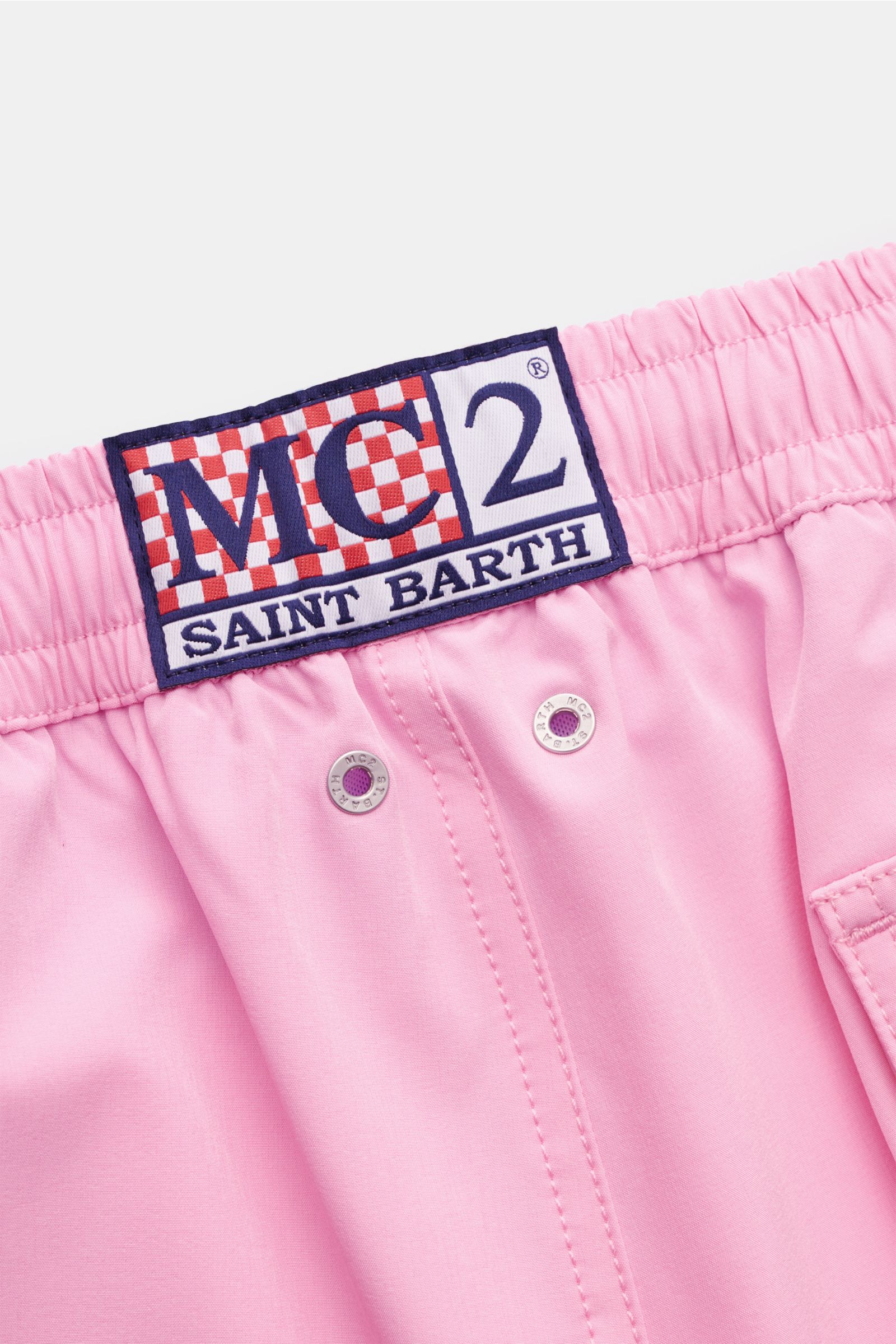 Close-up front view of MC2 Saint Barth Badeshorts 'Comfort' rosé waistband with elastic band, logo patch, and metal eyelets.

Tauchen Sie ein in die erfrischende Welt von MC2 SAINT BARTH: Die Badeshorts 'Comfort' aus leichter, schnell trocknender Micro