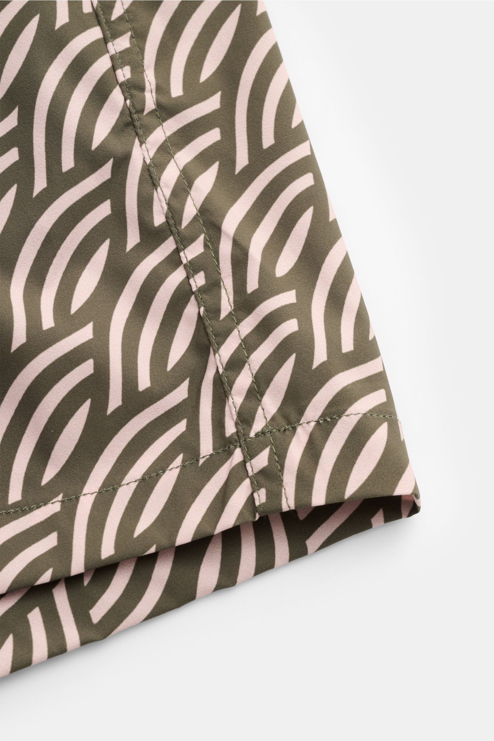 Close-up side view of Moorer Swim shorts dark green/antique pink patterned showing fabric and stitching details, featuring quick-drying microfibre, smooth feel, regular fit, elasticated waistband with drawstring, small key pocket inside, side seam pockets