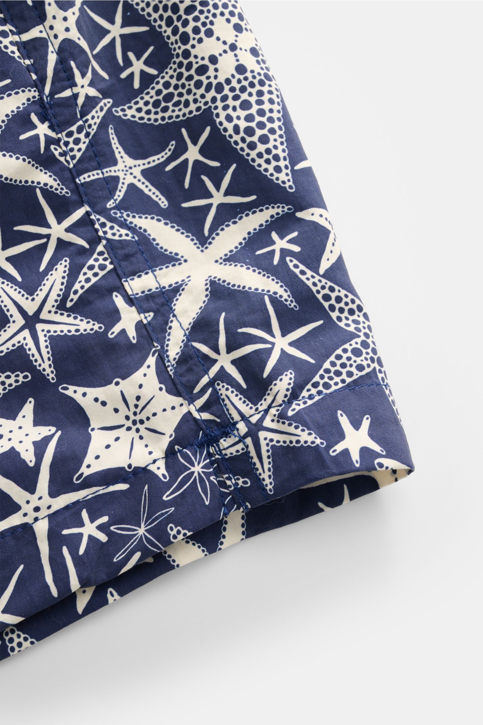 Nahaufnahme der Zeybra Portofino 1962 Badeshorts navy/offwhite gemustert im Beach-Look mit maritimem Print, glattem Griff und kurzen Saumschlitzen.